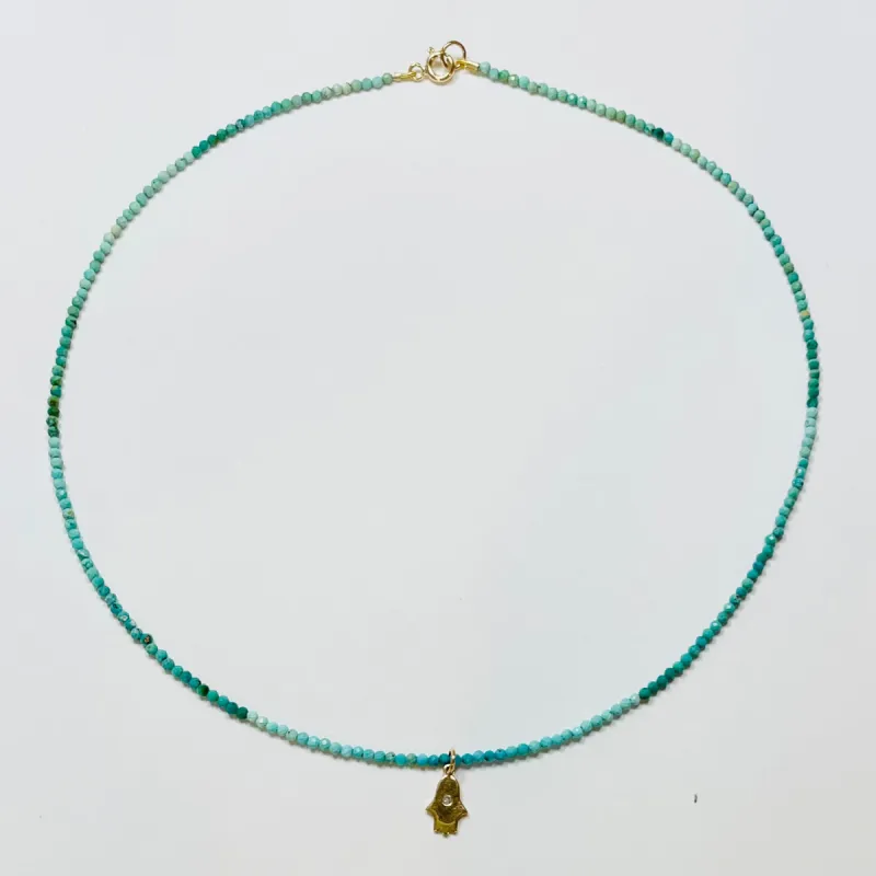 delicate shaded turquoise necklace with hamsa charm sold by Theodosia