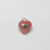 puffy rhodochrosite heart pendant with 14 kt gold bezel emerald sold by Theodosia