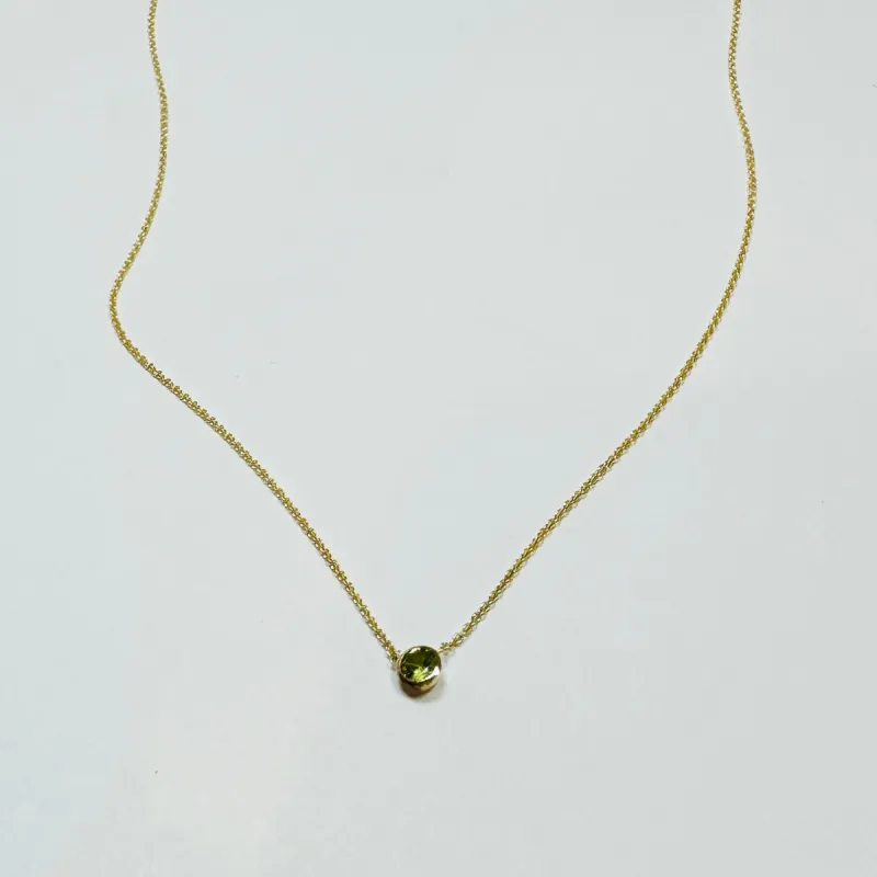 bezel set peridot necklace sold by Theodosia