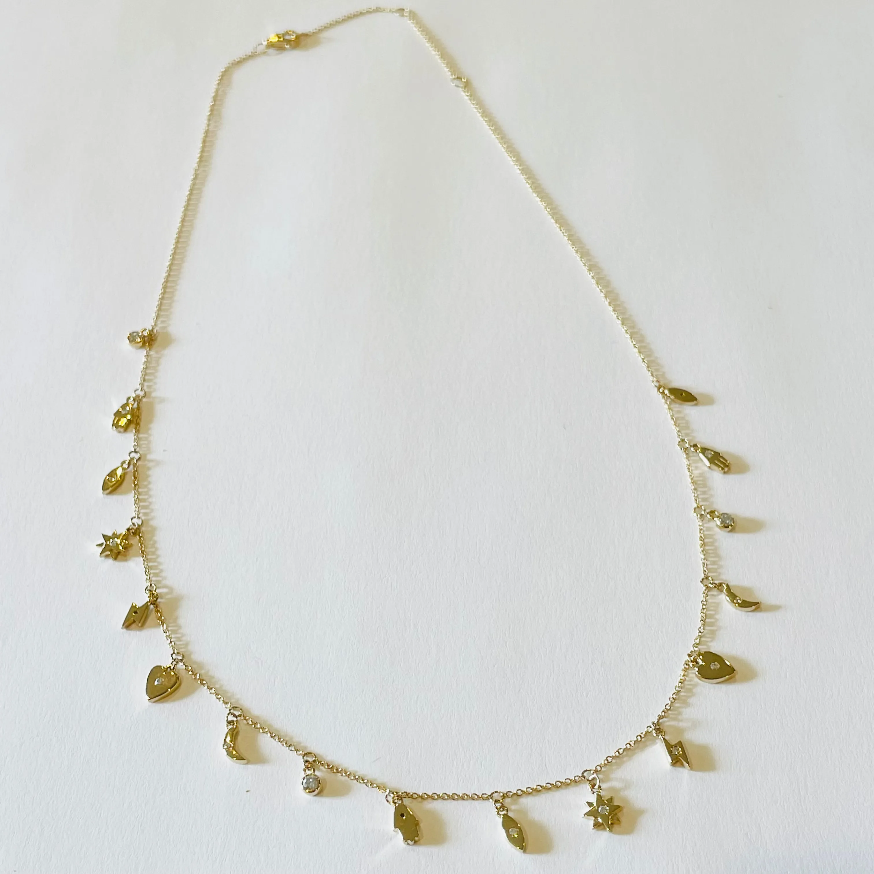 gold charm necklace sold by Theodosia