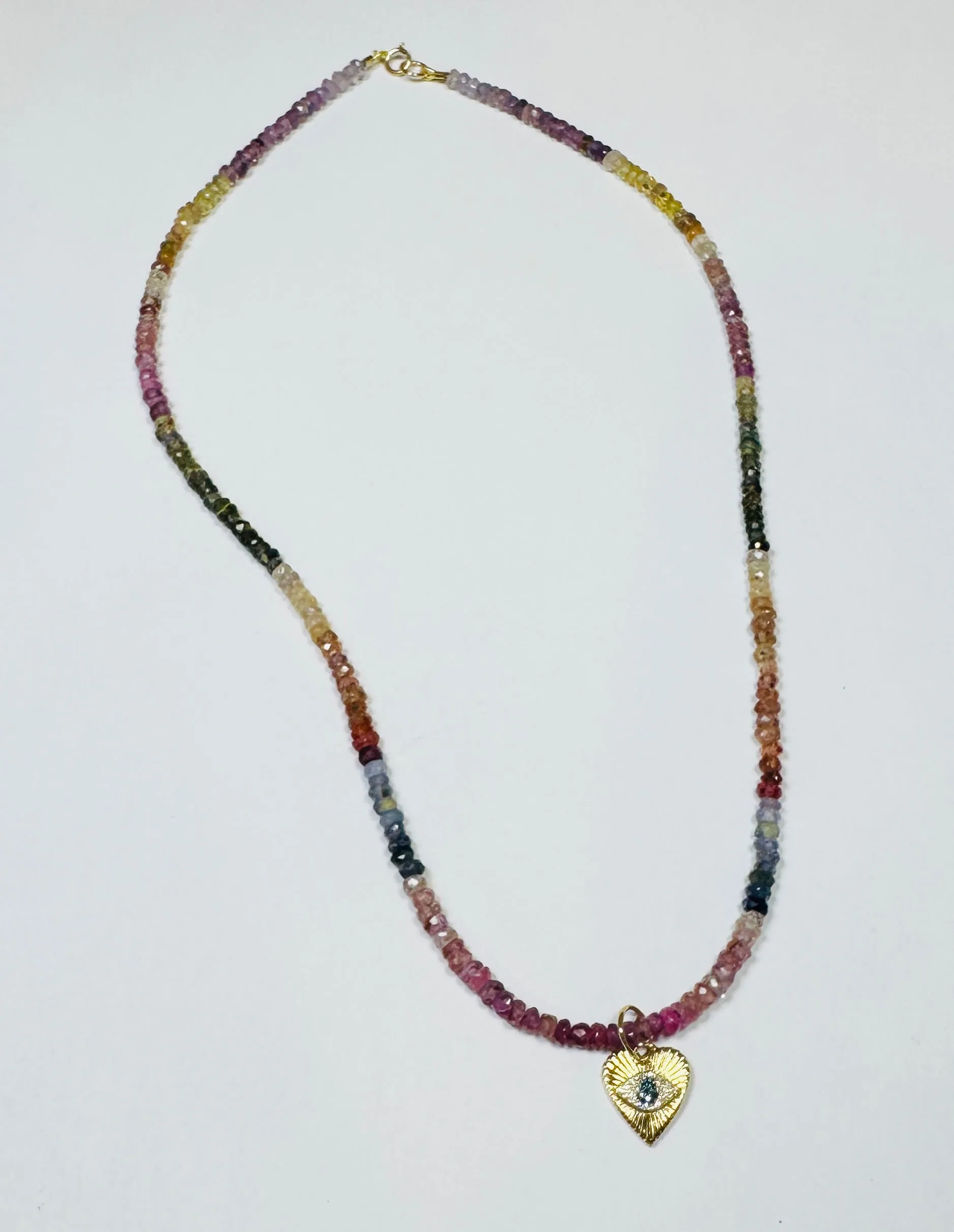 shaded sapphire necklace with evil eye heart sold by Theodosia