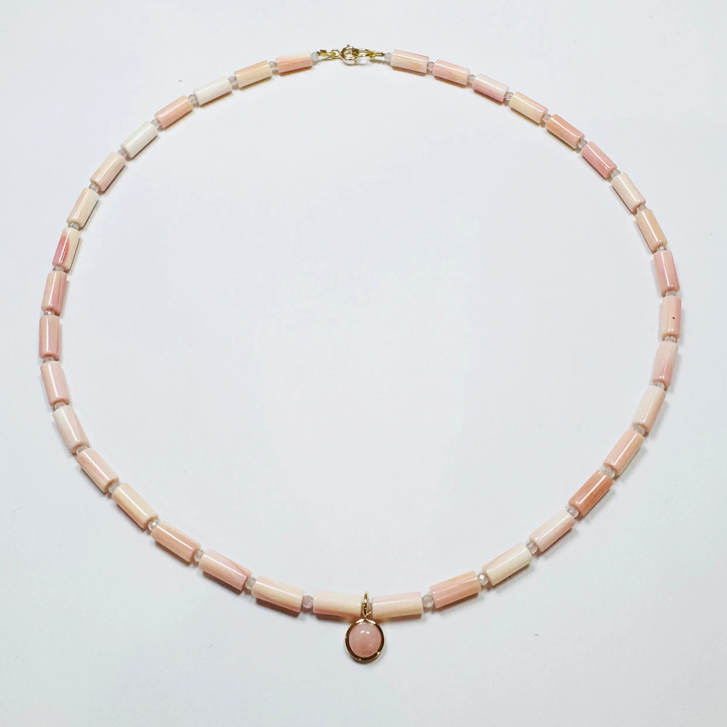 tube pink conch necklace with opal charm sold by Theodosia