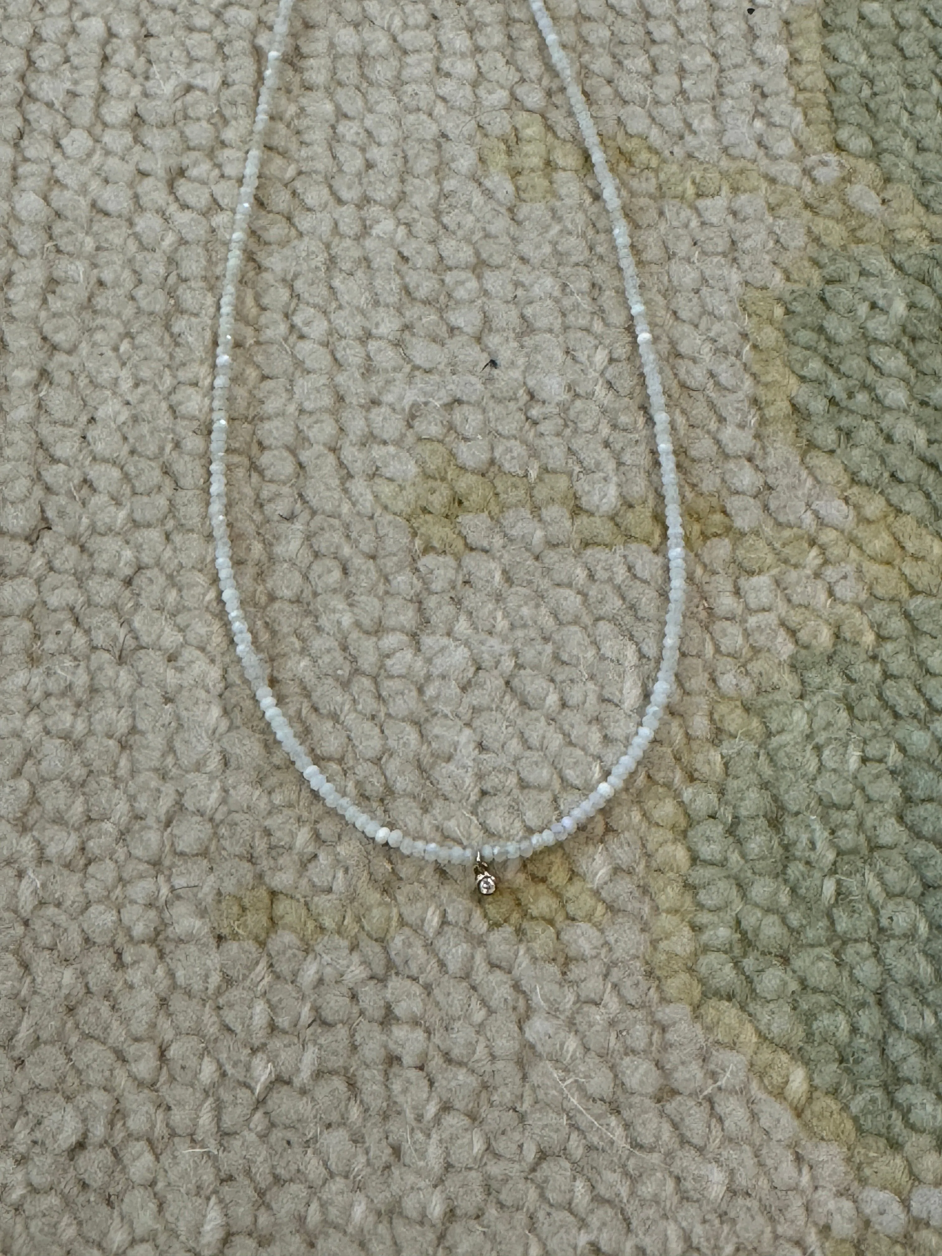 delicate opal necklace with bezel diamond charm sold by Theodosia