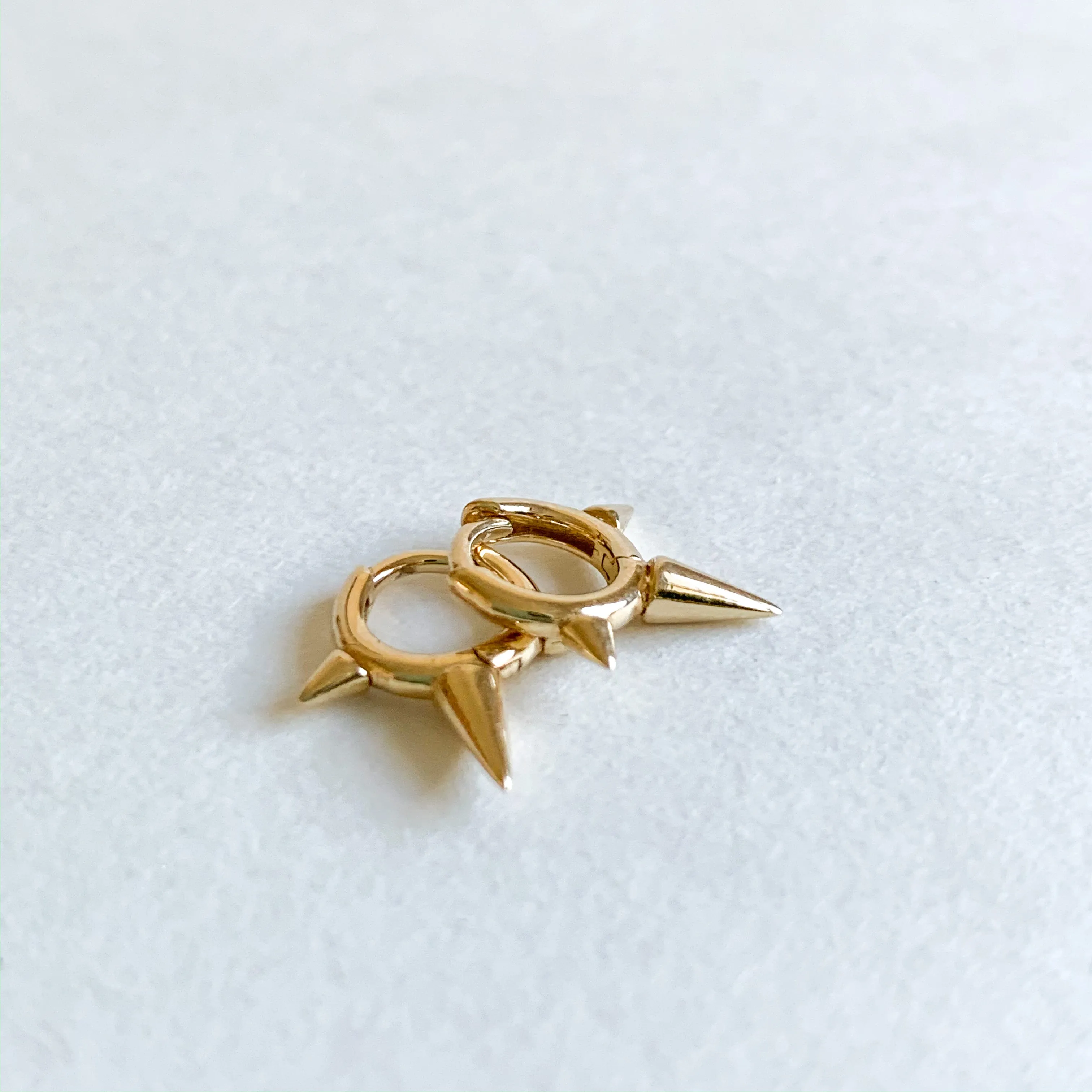 tiny gold spike huggies sold by Theodosia