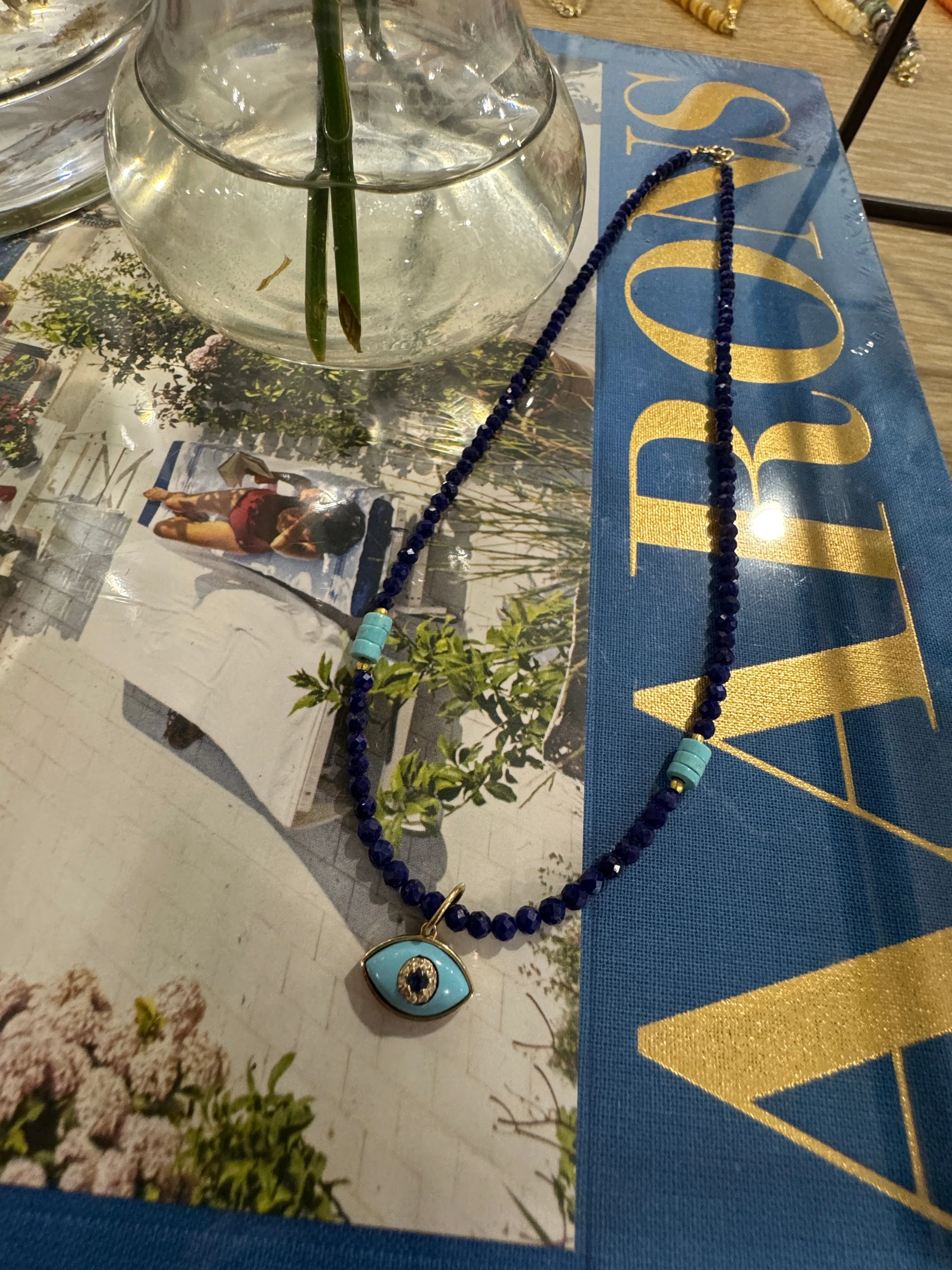 delicate lapis necklace with evil eye charm sold by Theodosia