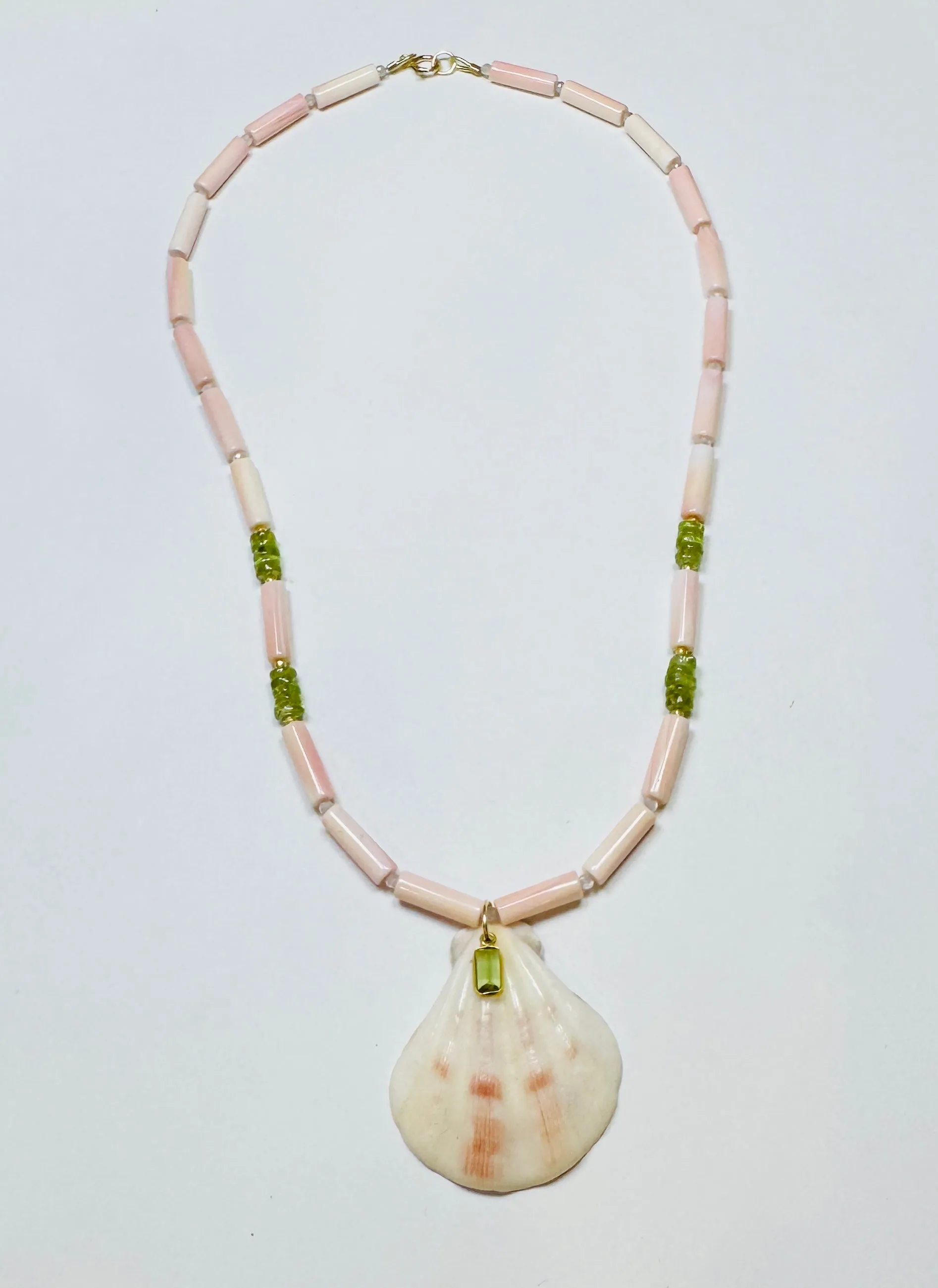 tube conch and peridot necklace with strawberry shell pendant sold by Theodosia
