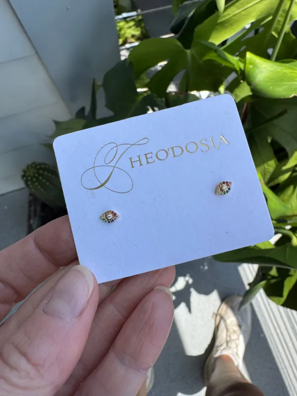rainbow evil eye studs sold by Theodosia
