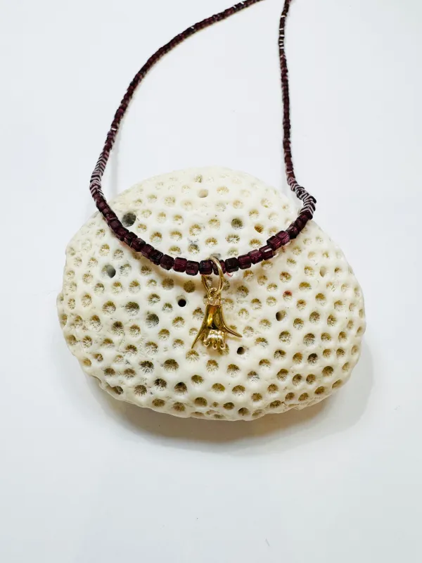 delicate garnet block necklace with spurs up charm sold by Theodosia