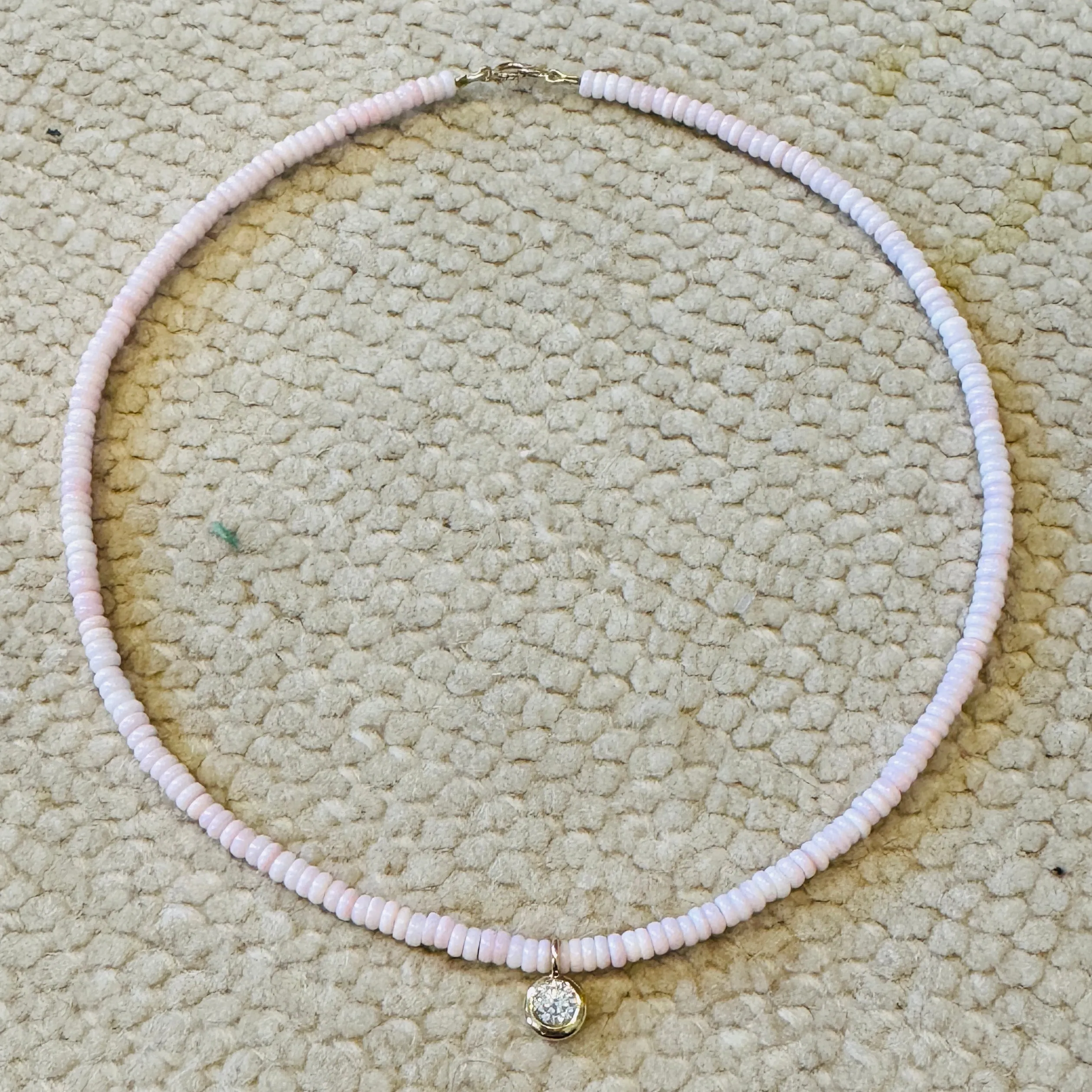 conch necklace with bezel diamond charm sold by Theodosia