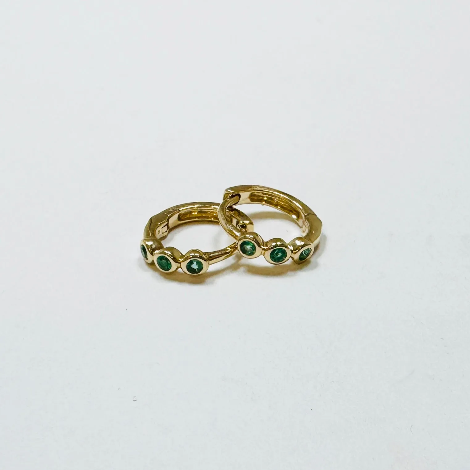 bezel emerald huggies sold by Theodosia
