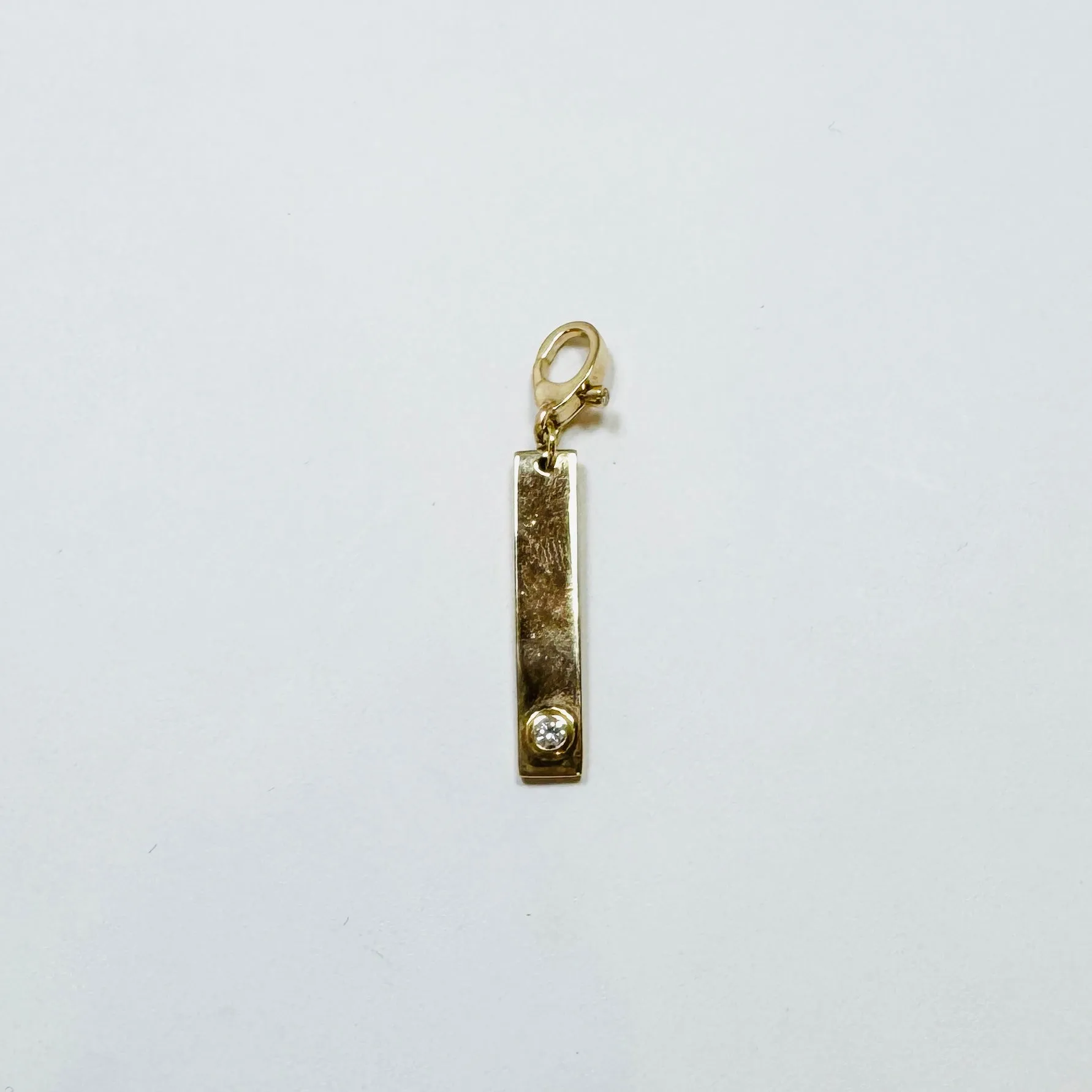 gold bezel set diamond dog tag pendant sold by Theodosia