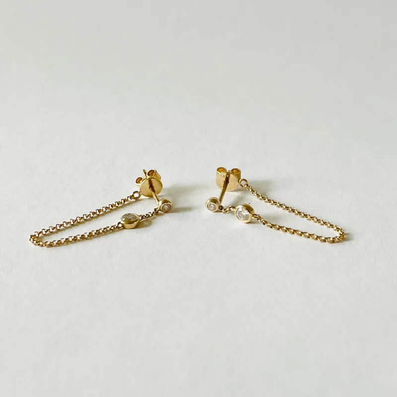 double bezel set diamond studs with chain sold by Theodosia