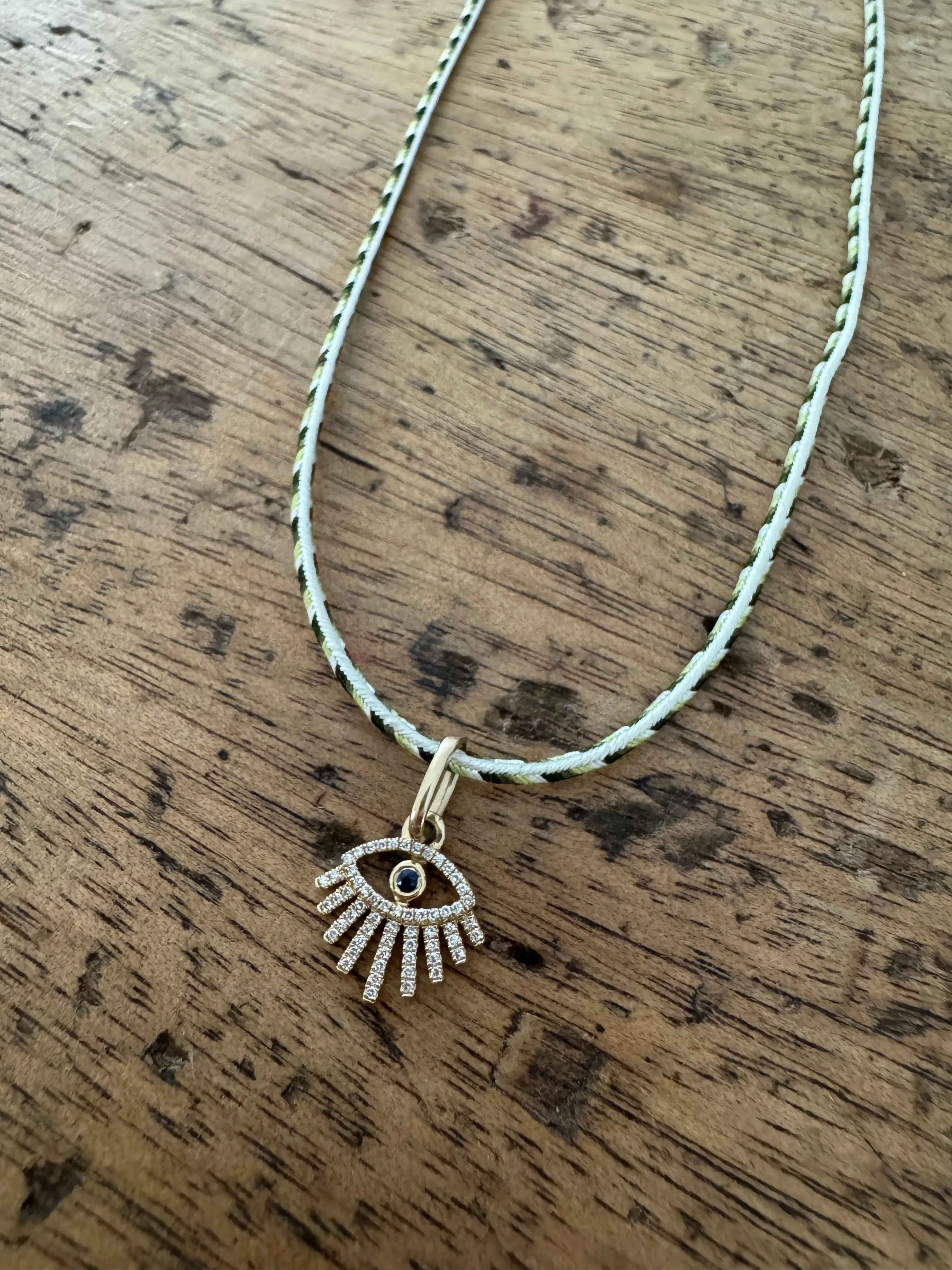 evil eye charm on Kumihimo silk cord sold by Theodosia