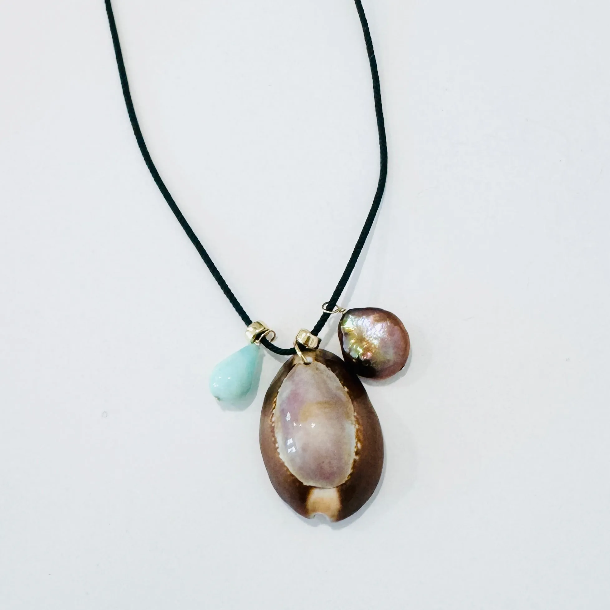 Kumihimo silk cord charm necklace, teal with blue opal, pearl, and purple cowrie shell sold by Theodosia
