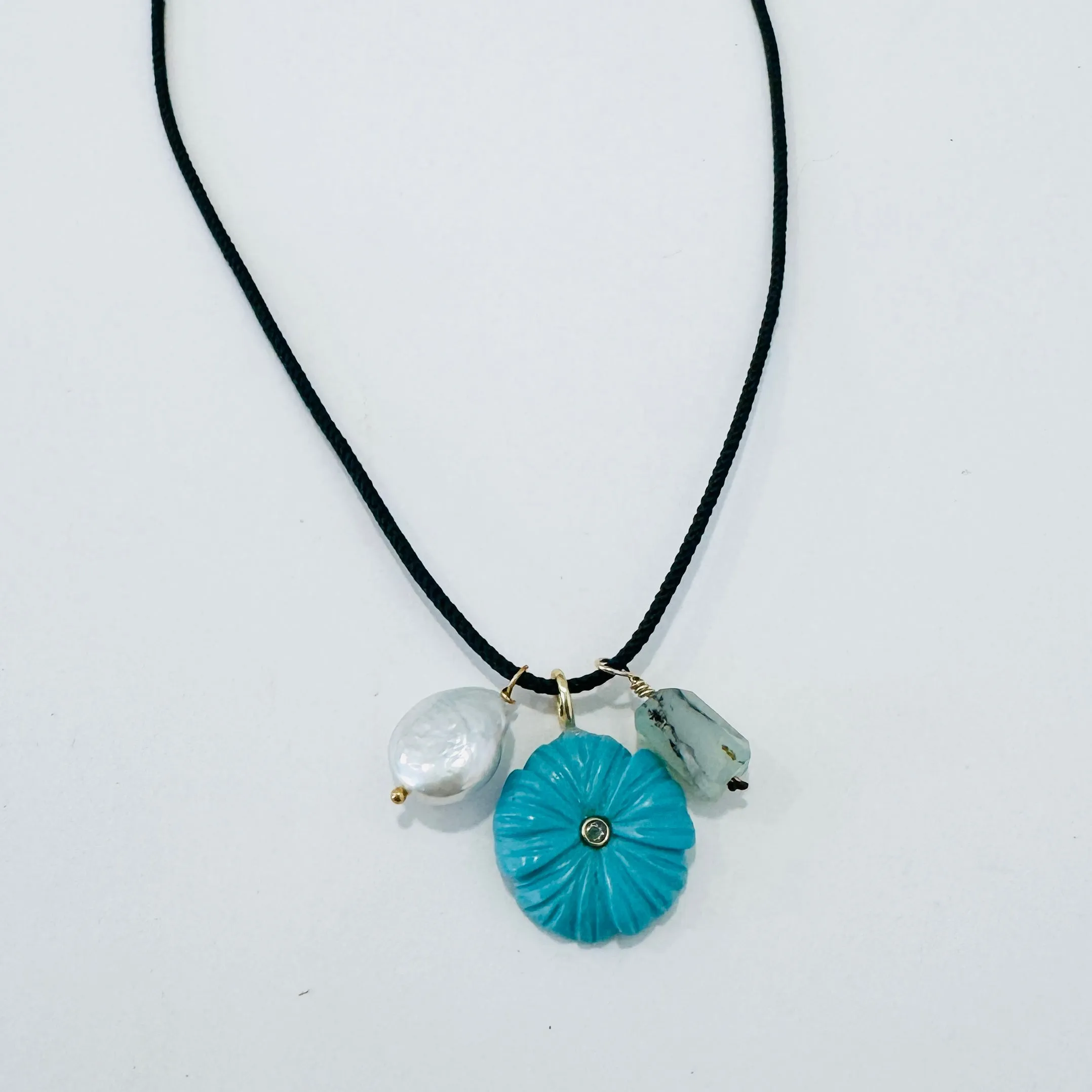 Kumihimo silk cord charm necklace, teal with pearl, quartz, and flower charm sold by Theodosia