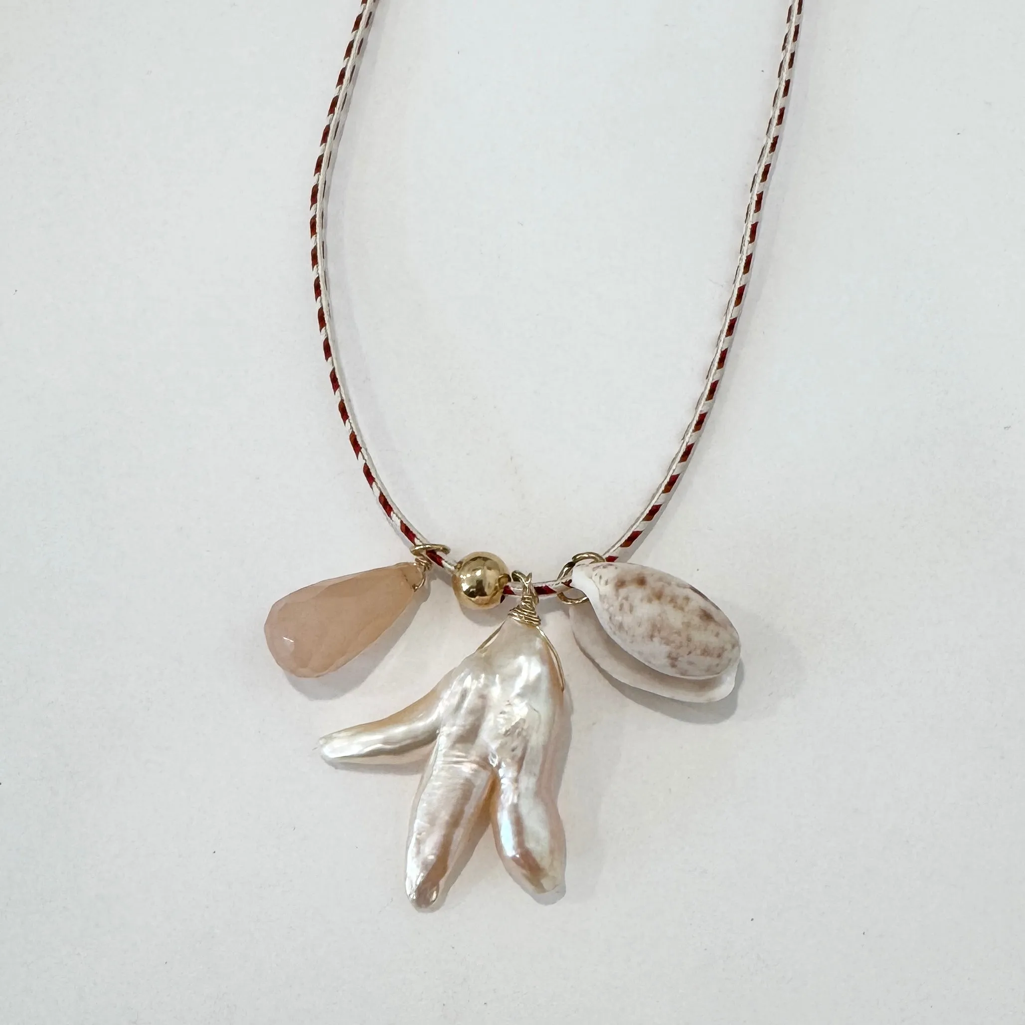 Kumihimo silk cord charm necklace, herringbone with pearl, peach quartz, and lettered olive sold by Theodosia