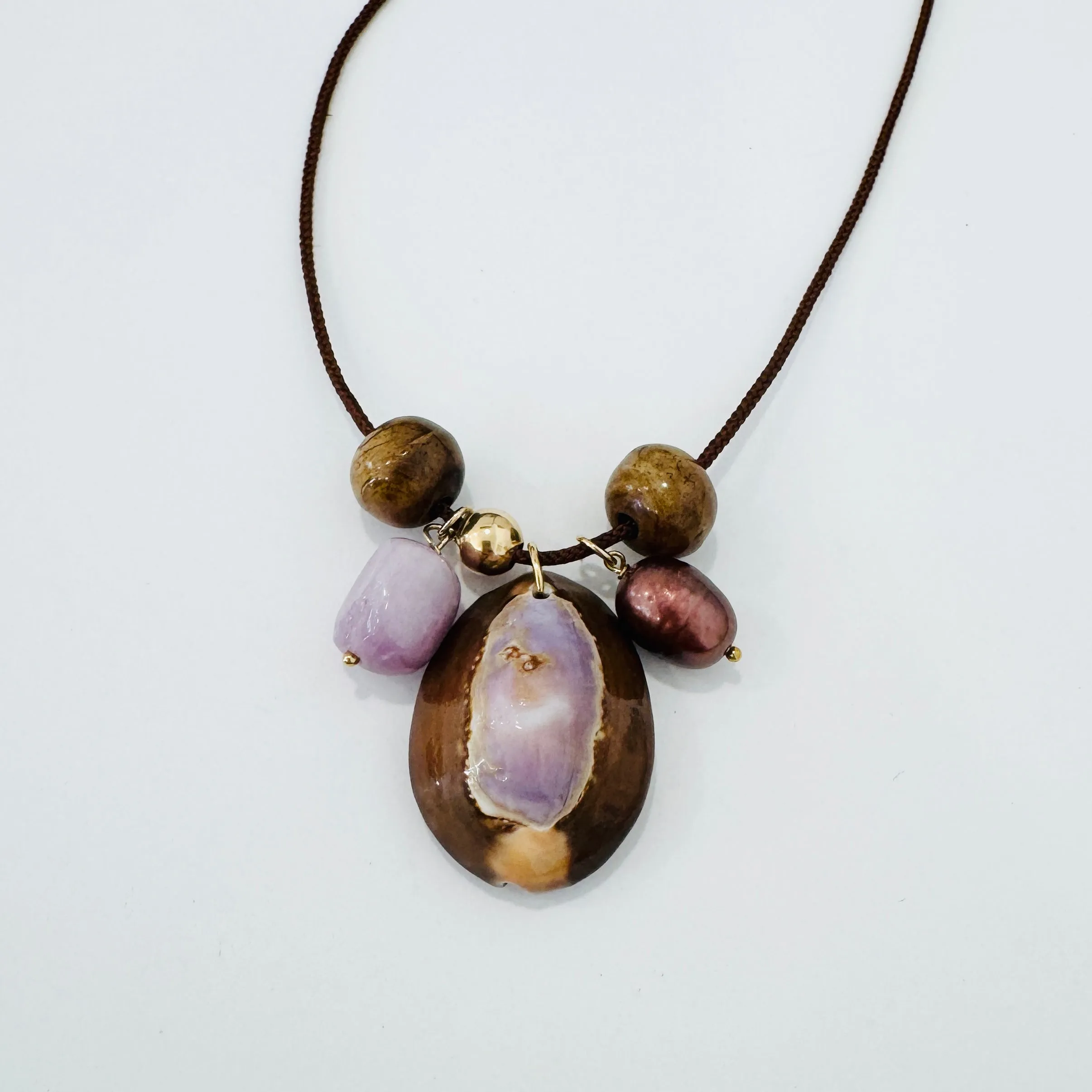 Kumihimo silk cord charm necklace, brown with kyanite, pearl, and purple cowrie shell sold by Theodosia