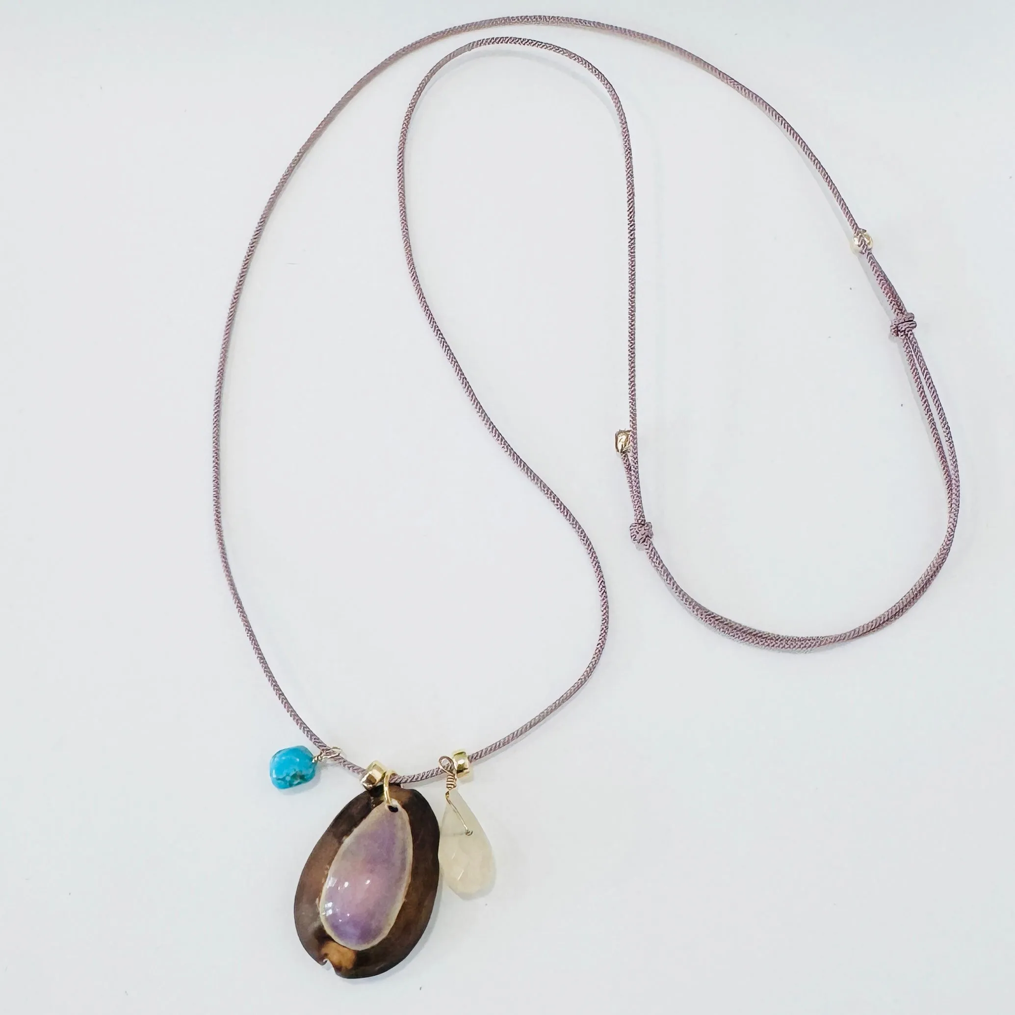 Kumihimo silk cord charm necklace, lavender with quartz, turquoise, and purple cowrie shell sold by Theodosia