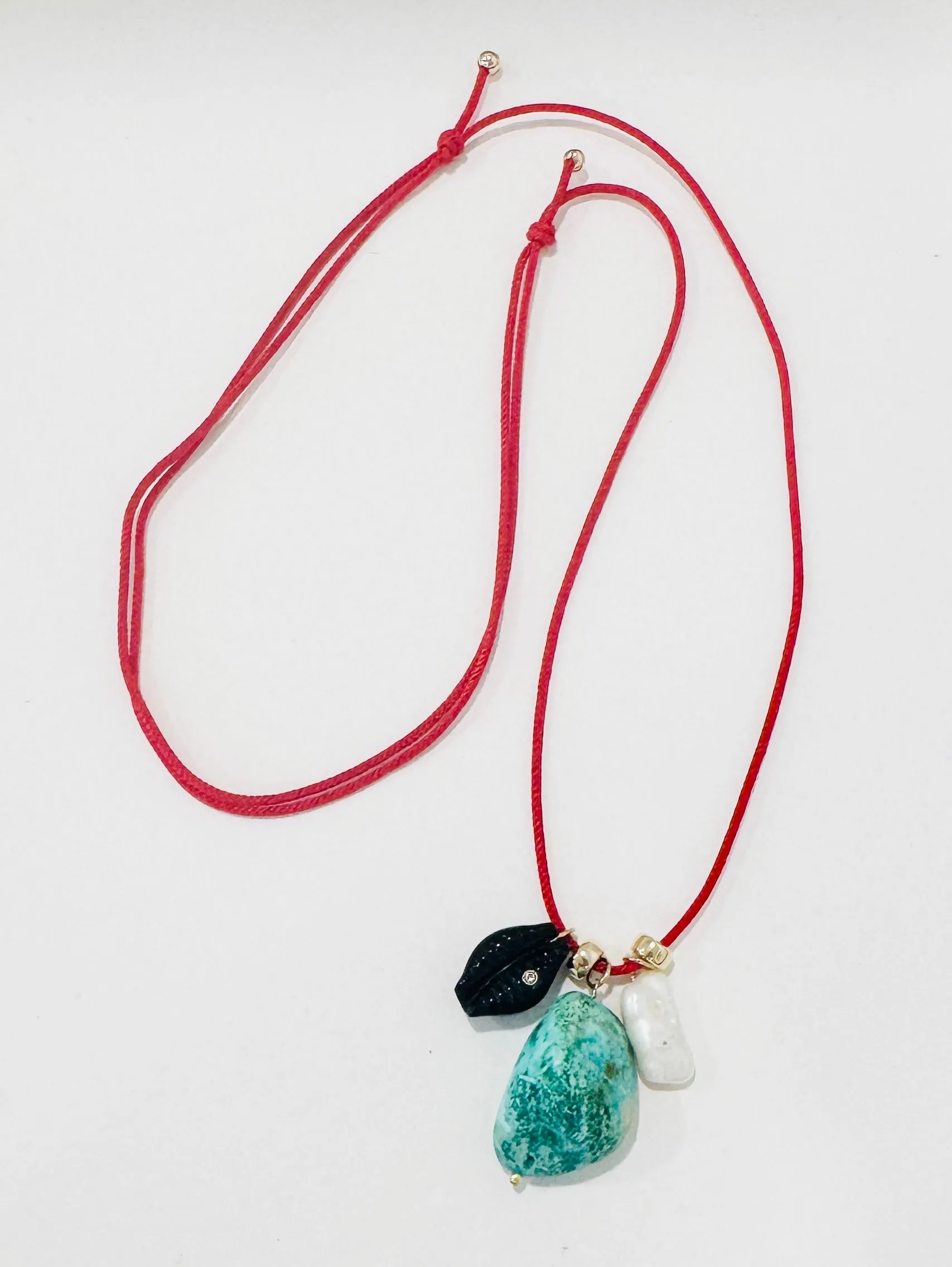 Kumihimo silk cord charm necklace, red with turquoise, pearl, and onyx cowrie shell sold by Theodosia