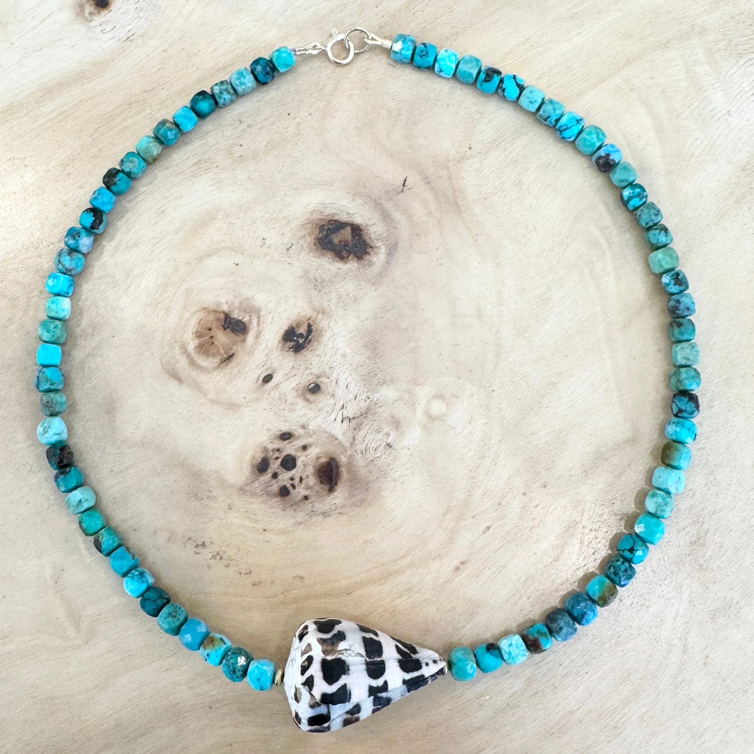 Shell, turquoise, and gold beads sold by Theodosia