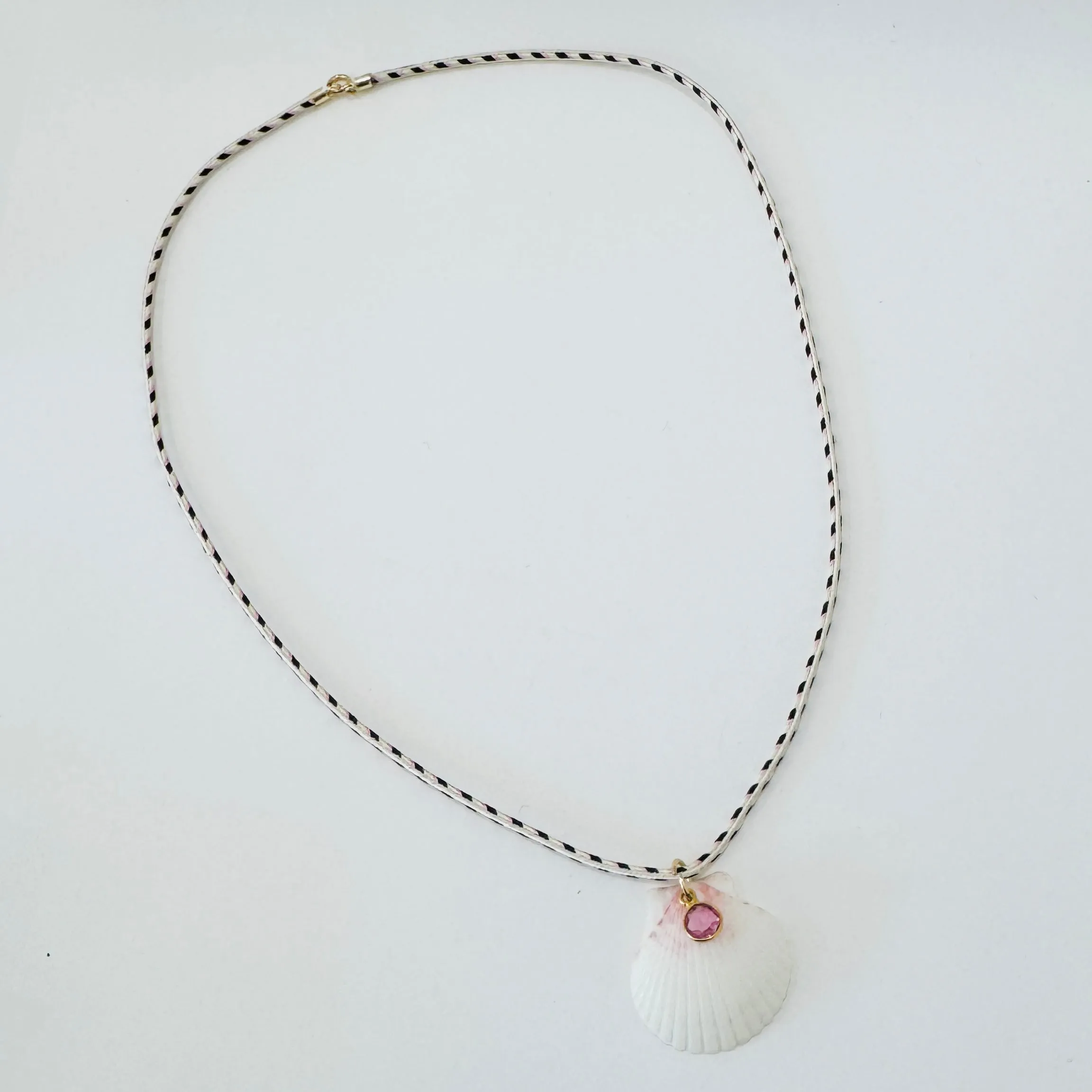 shell and pink sapphire on Kumihimo silk cord sold by Theodosia
