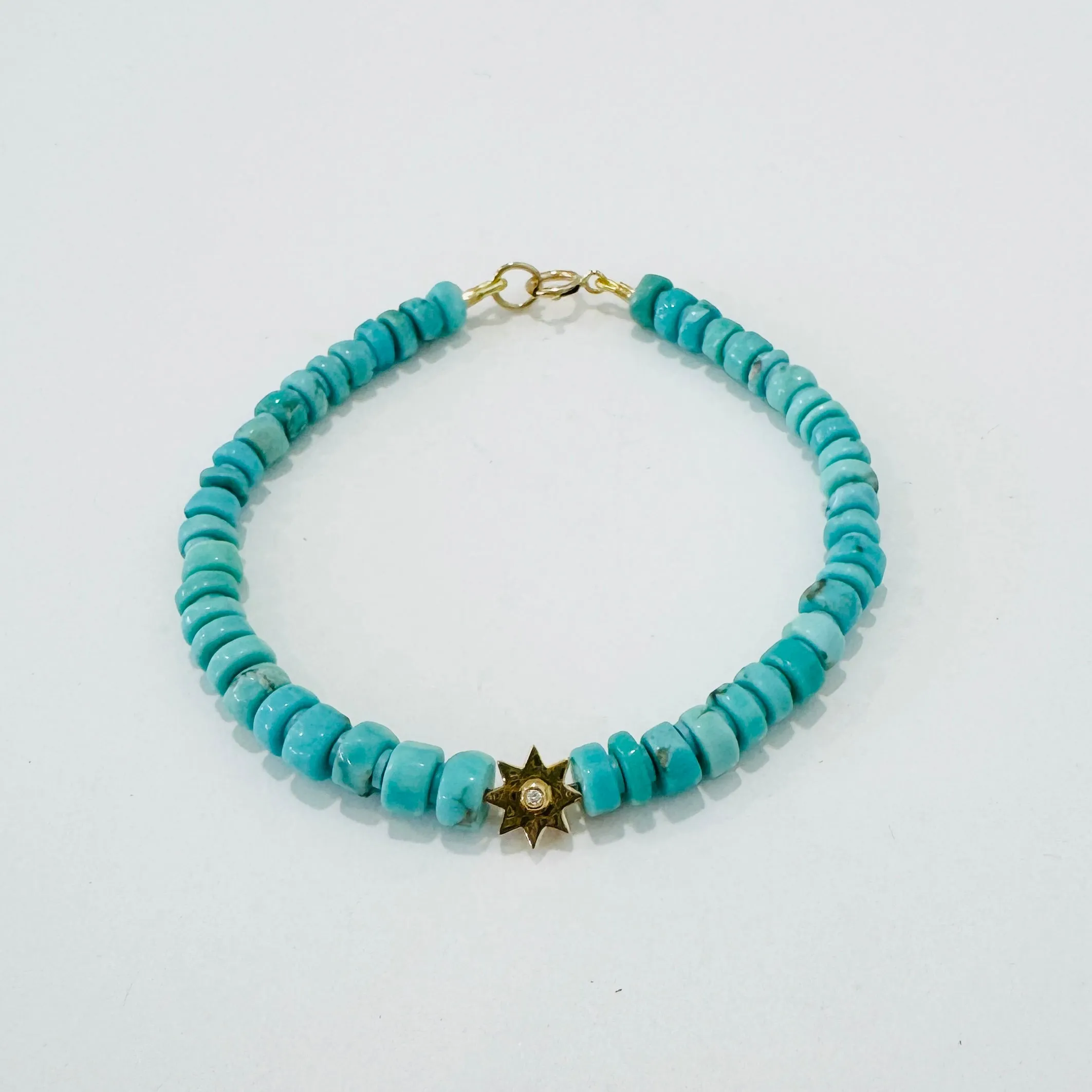 sleeping beauty turquoise bracelet with 14 kt gold starburst sold by Theodosia