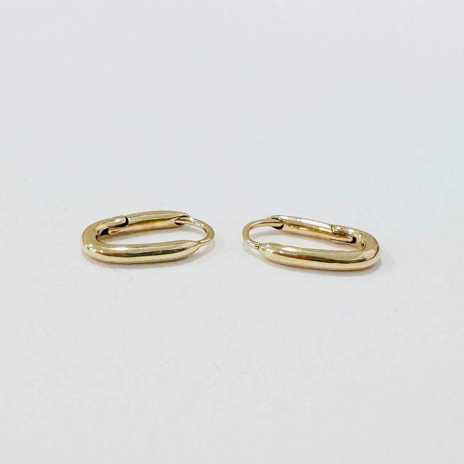 elongated gold huggies sold by Theodosia