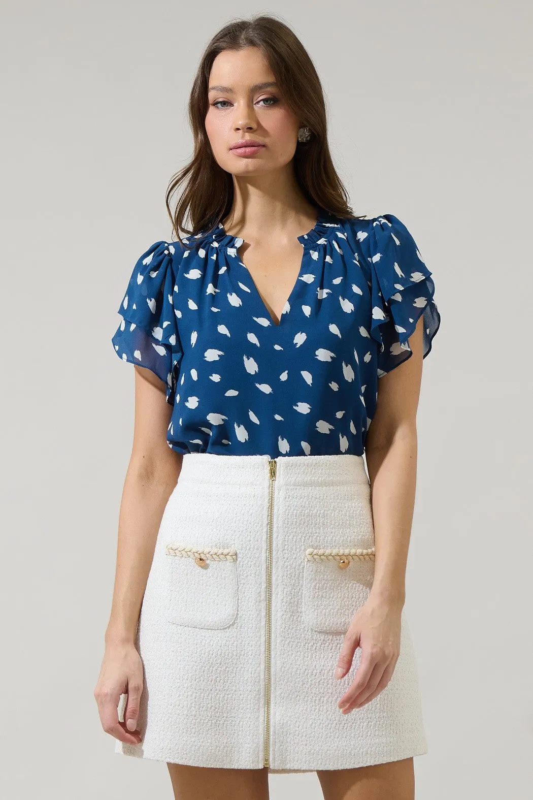 The Odora Dot Ruffle Blouse sold by Thread & Seed