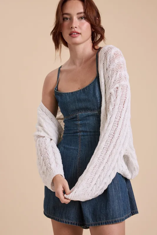 The Leslie White Cable Knitted Cardigan sold by Thread & Seed