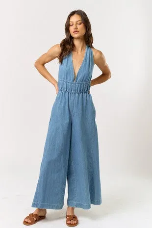 The Daniela Denim Halter Jumpsuit sold by Thread & Seed