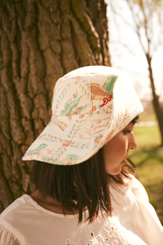 padded sunhat with popper in tea towl print sold by Damson Madder
