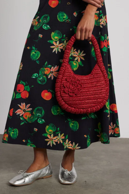 straw rosette bag sold by Damson Madder