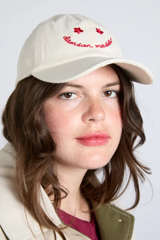 Smiley Cap in Natural with Red Embroidery sold by Damson Madder