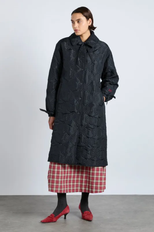 aubrey quilted coat- black bows sold by Damson Madder