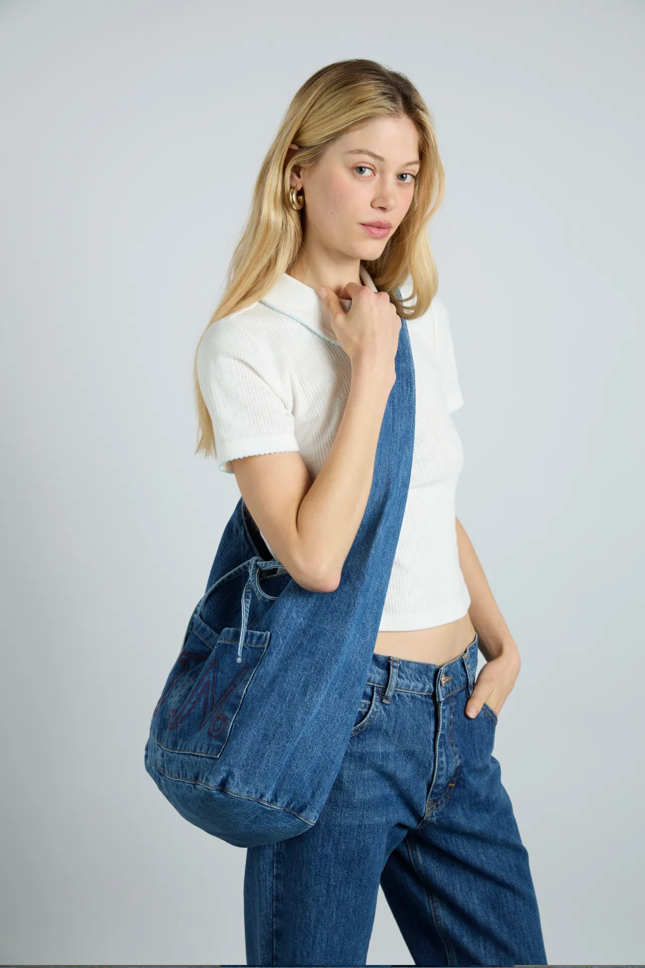 denim sling bag with pocket detail sold by Damson Madder
