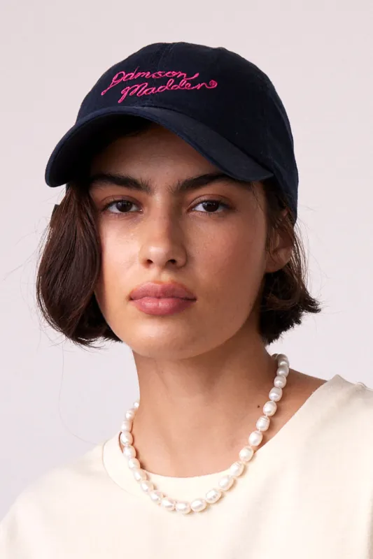 navy embroidered cap sold by Damson Madder