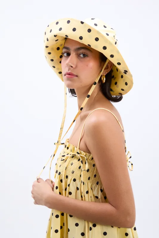 sunhat in butter yellow & black polka dot sold by Damson Madder