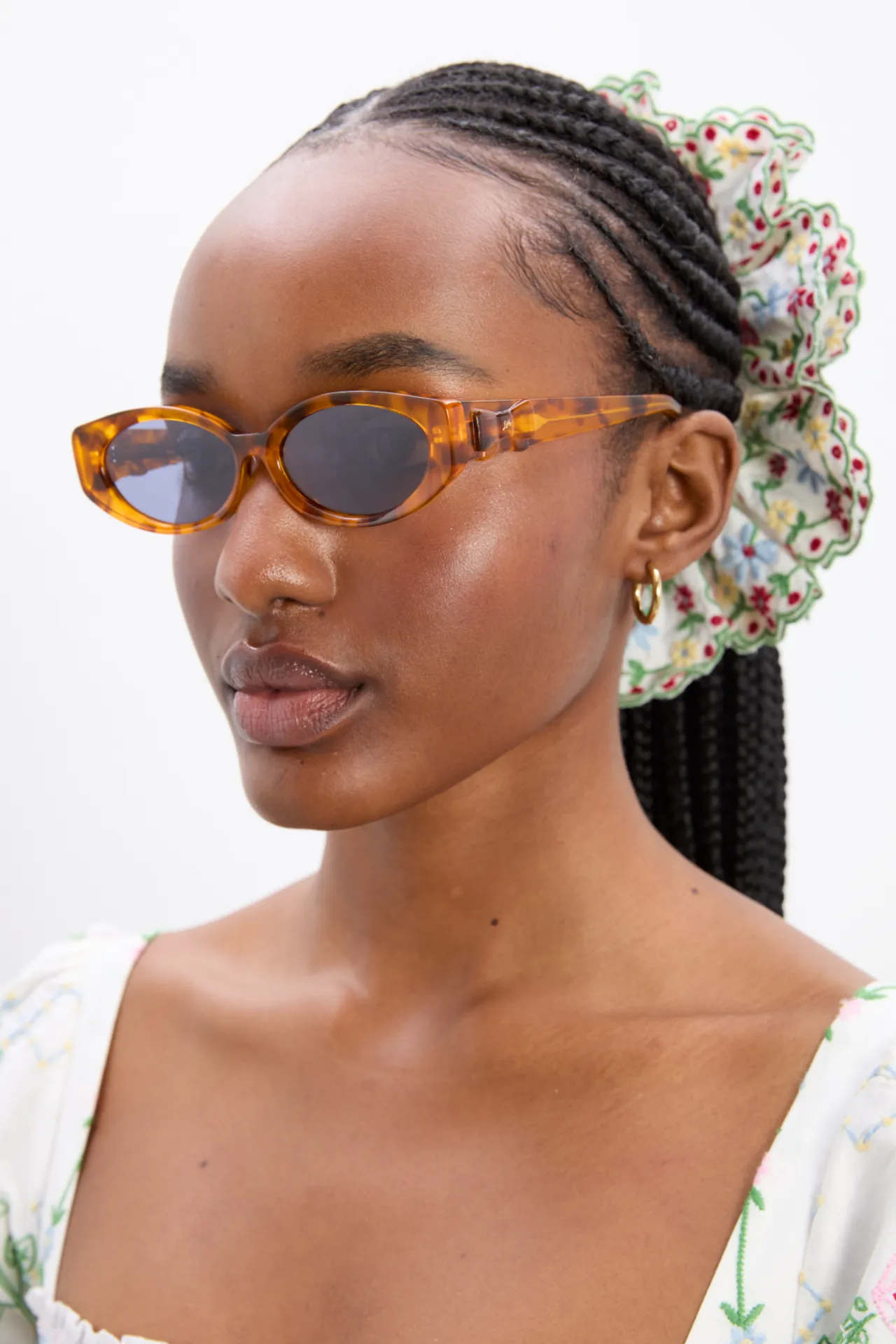 Catty Oval Sunglasses With Bow Detail In Tort sold by Damson Madder