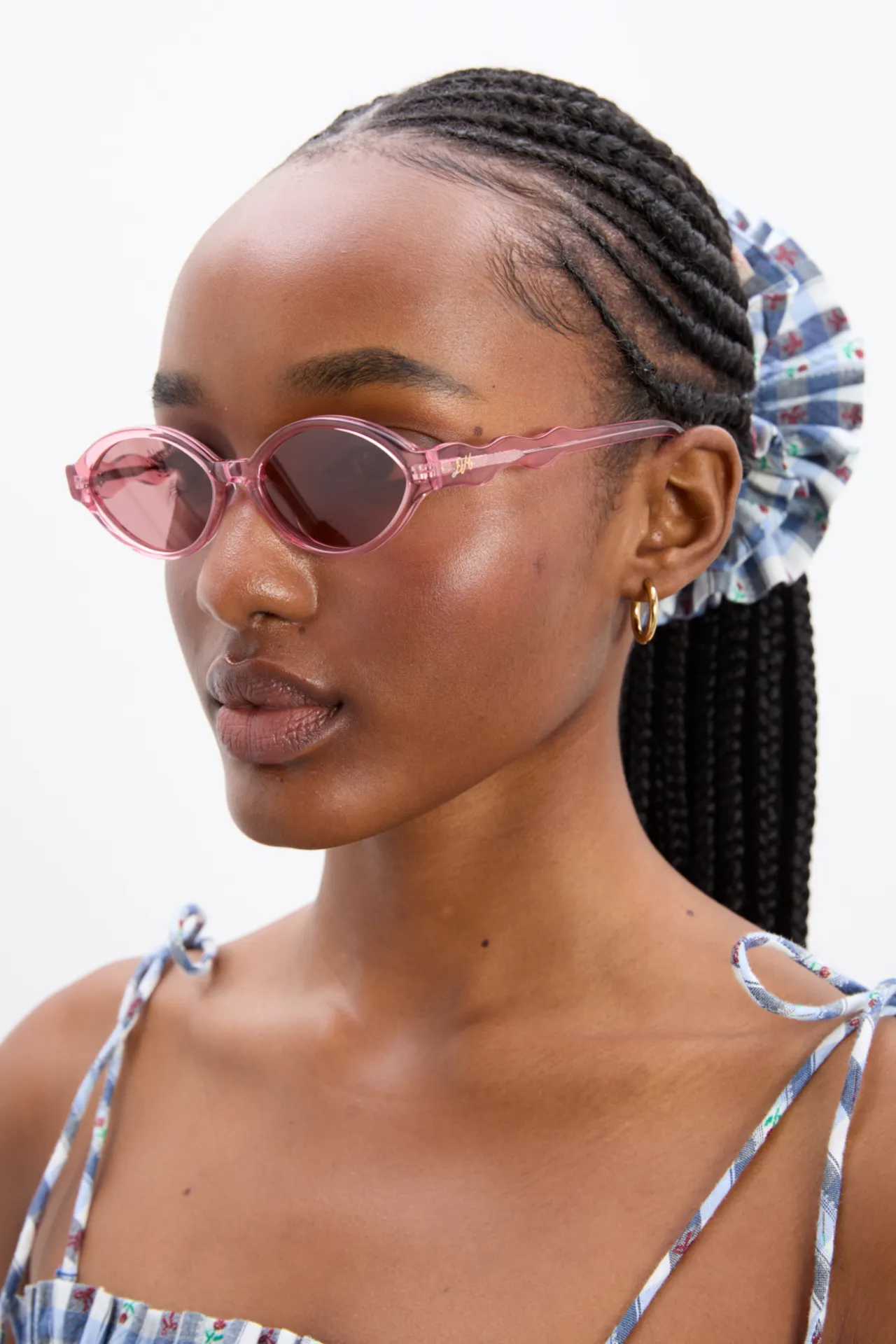 slim oval sunglasses with wavy temple in pink sold by Damson Madder