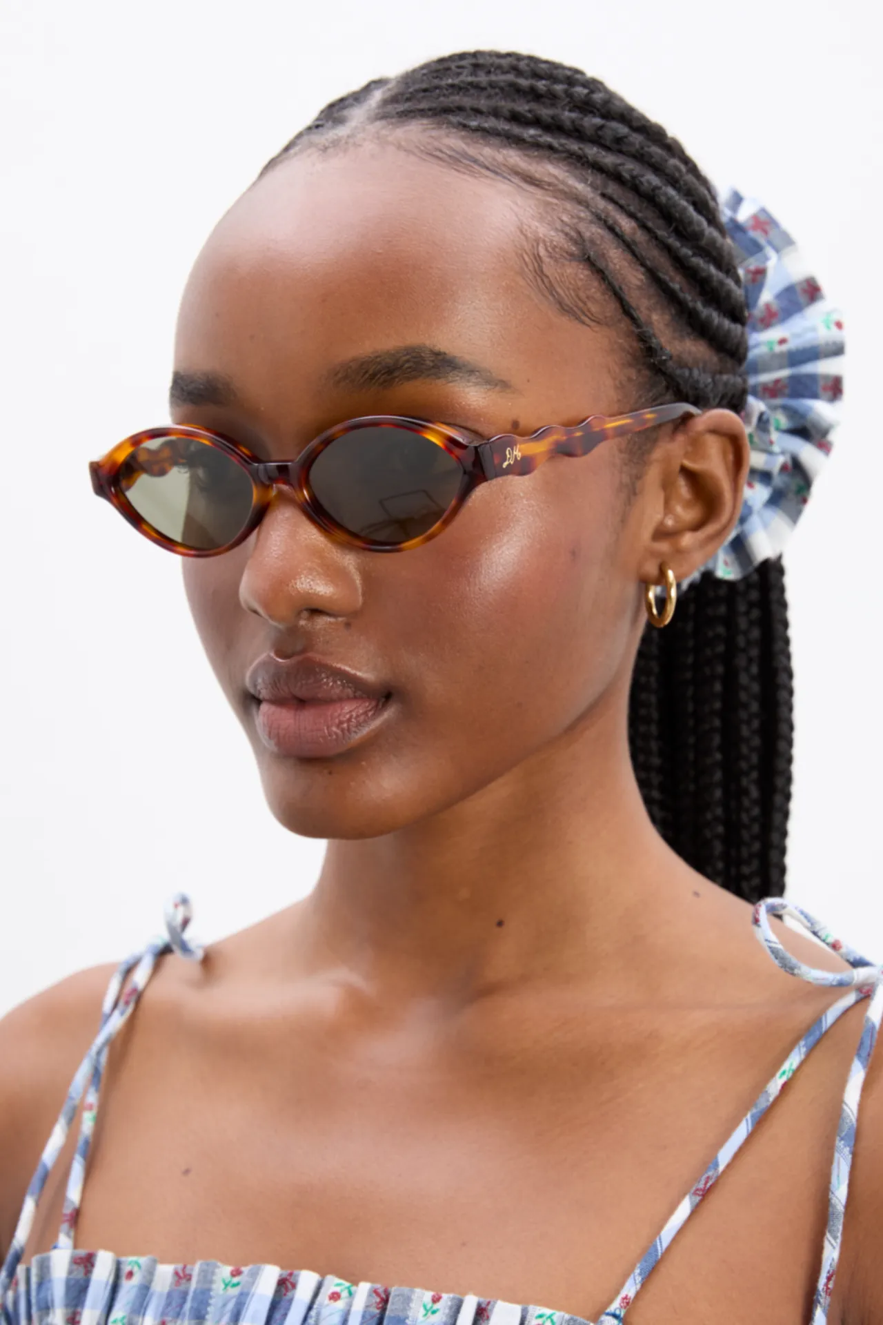 slim oval sunglasses with wavy temple in tort sold by Damson Madder