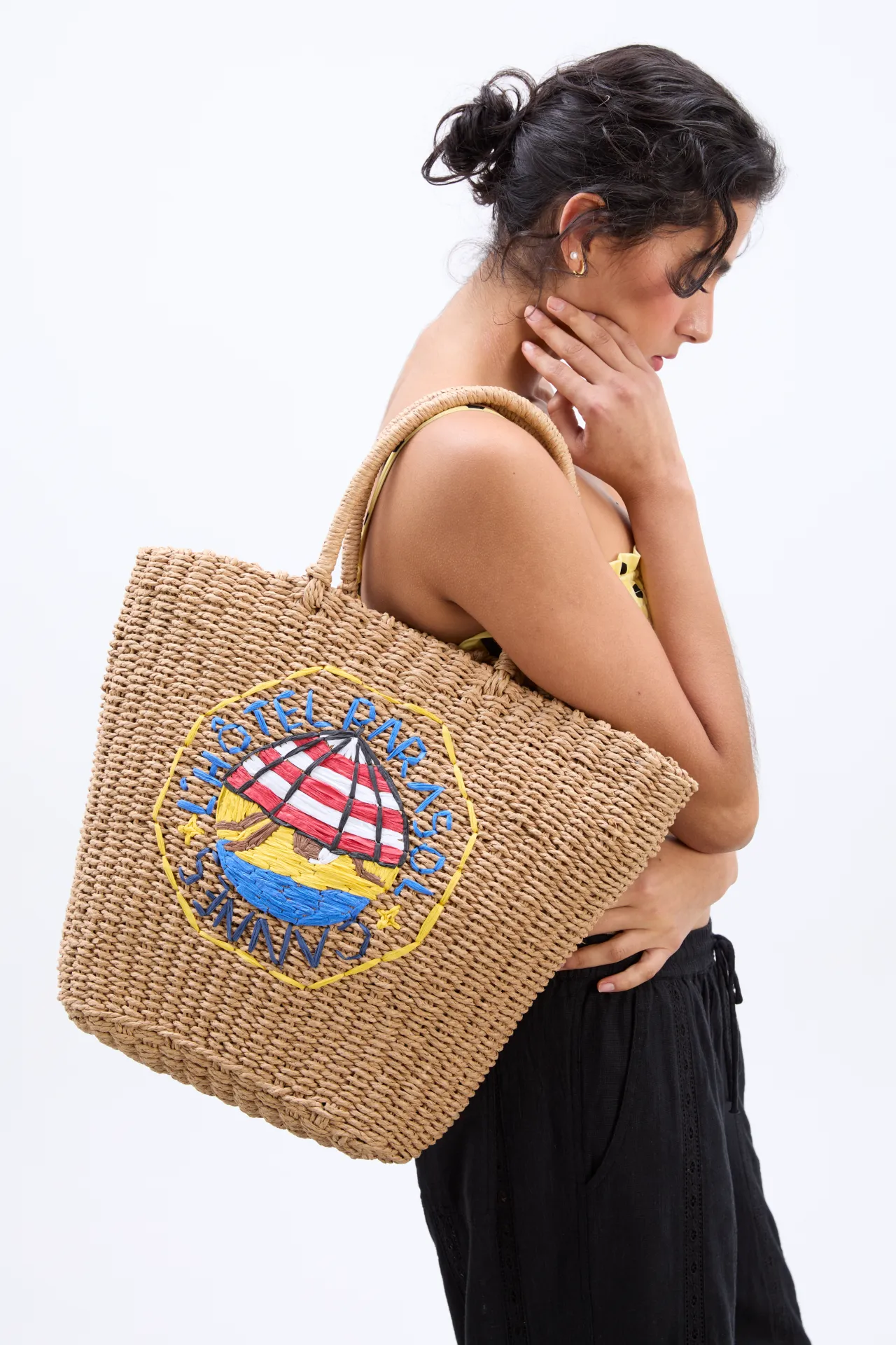 straw market bag with l'hotel embroidery sold by Damson Madder