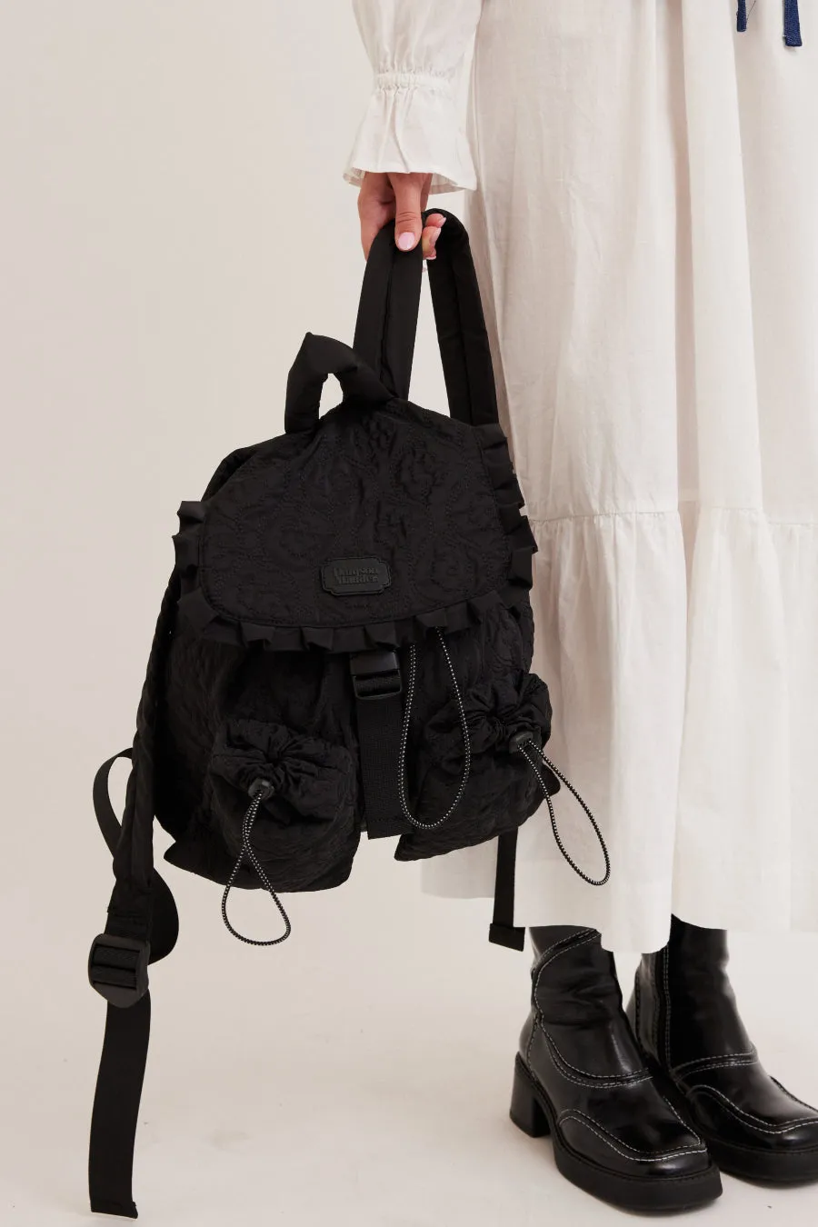 frill backpack in black floral stitch sold by Damson Madder