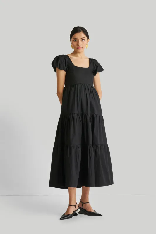 Puff Sleeved Tiered Maxi Dress in Black sold by Summersalt