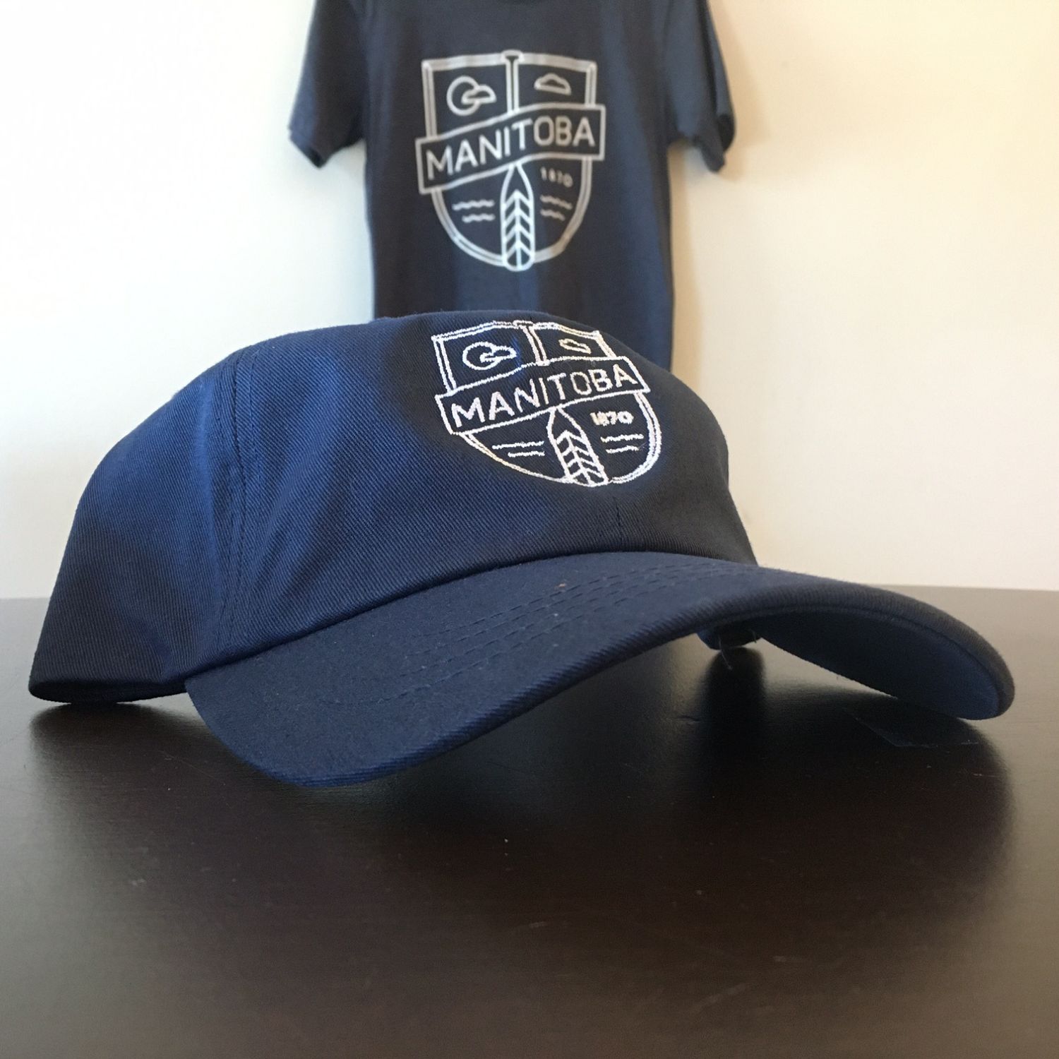 MB Cottage Dad Hat | White on Navy sold by We Heart Winnipeg