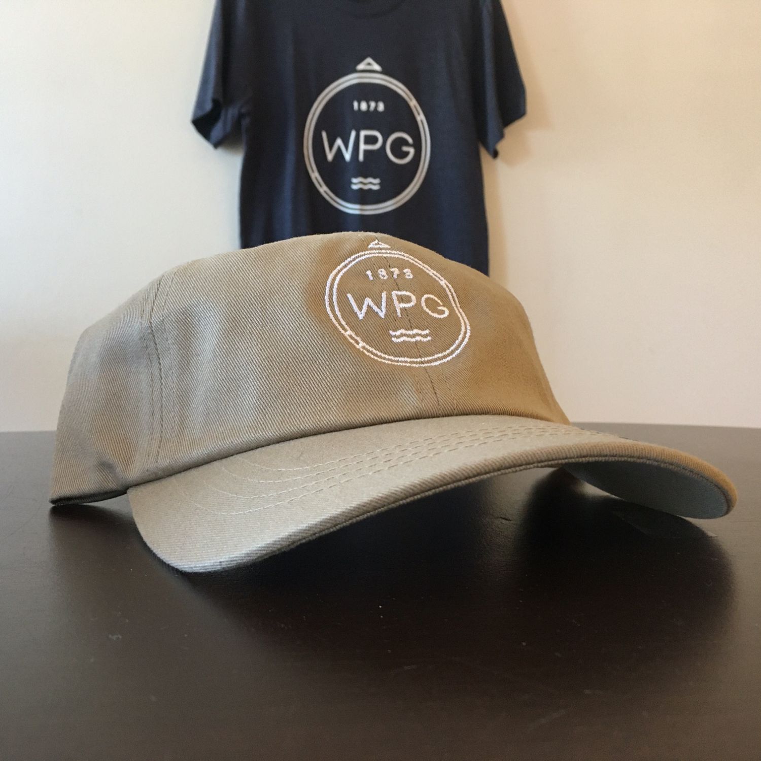 WPG Compass Dad Hat | White on Tan sold by We Heart Winnipeg