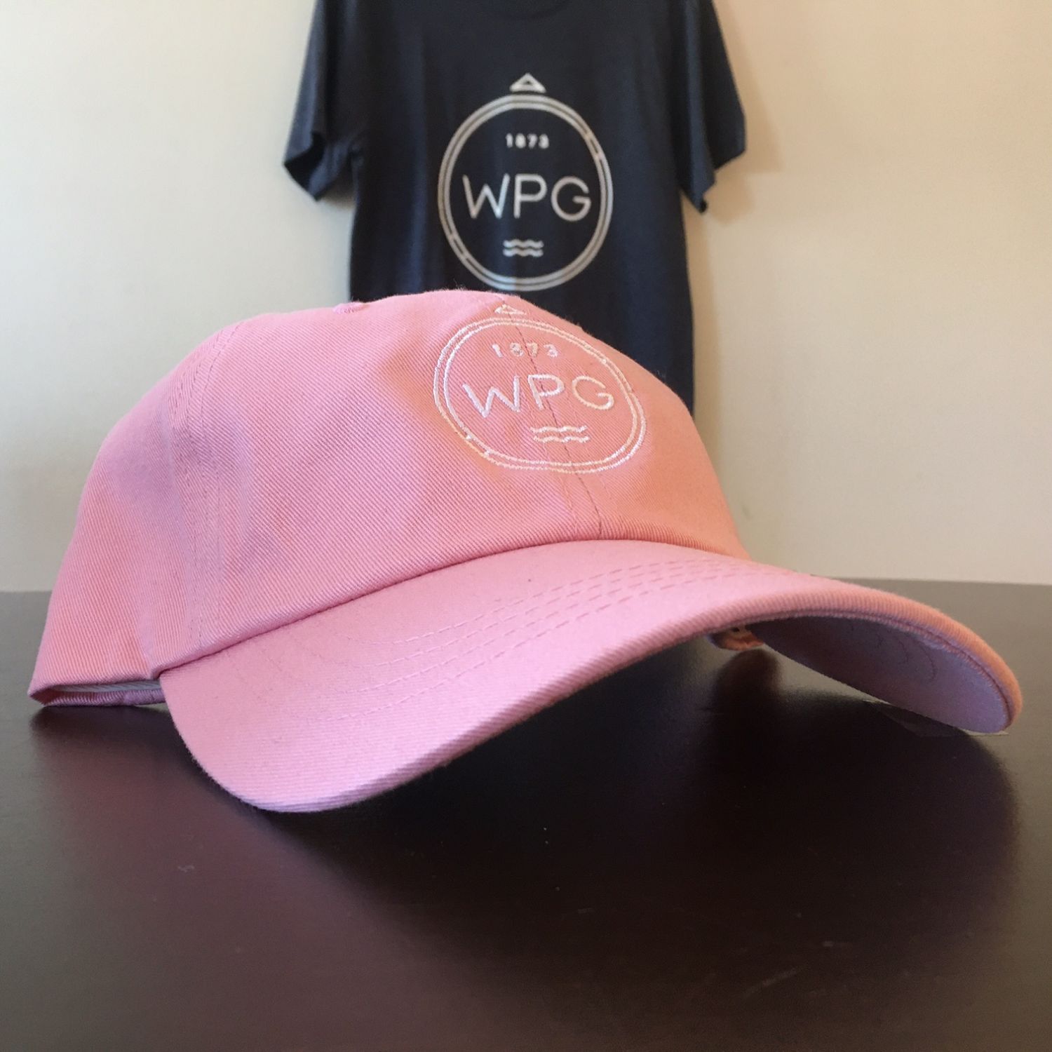 WPG Compass Dad Hat | White on Pink sold by We Heart Winnipeg
