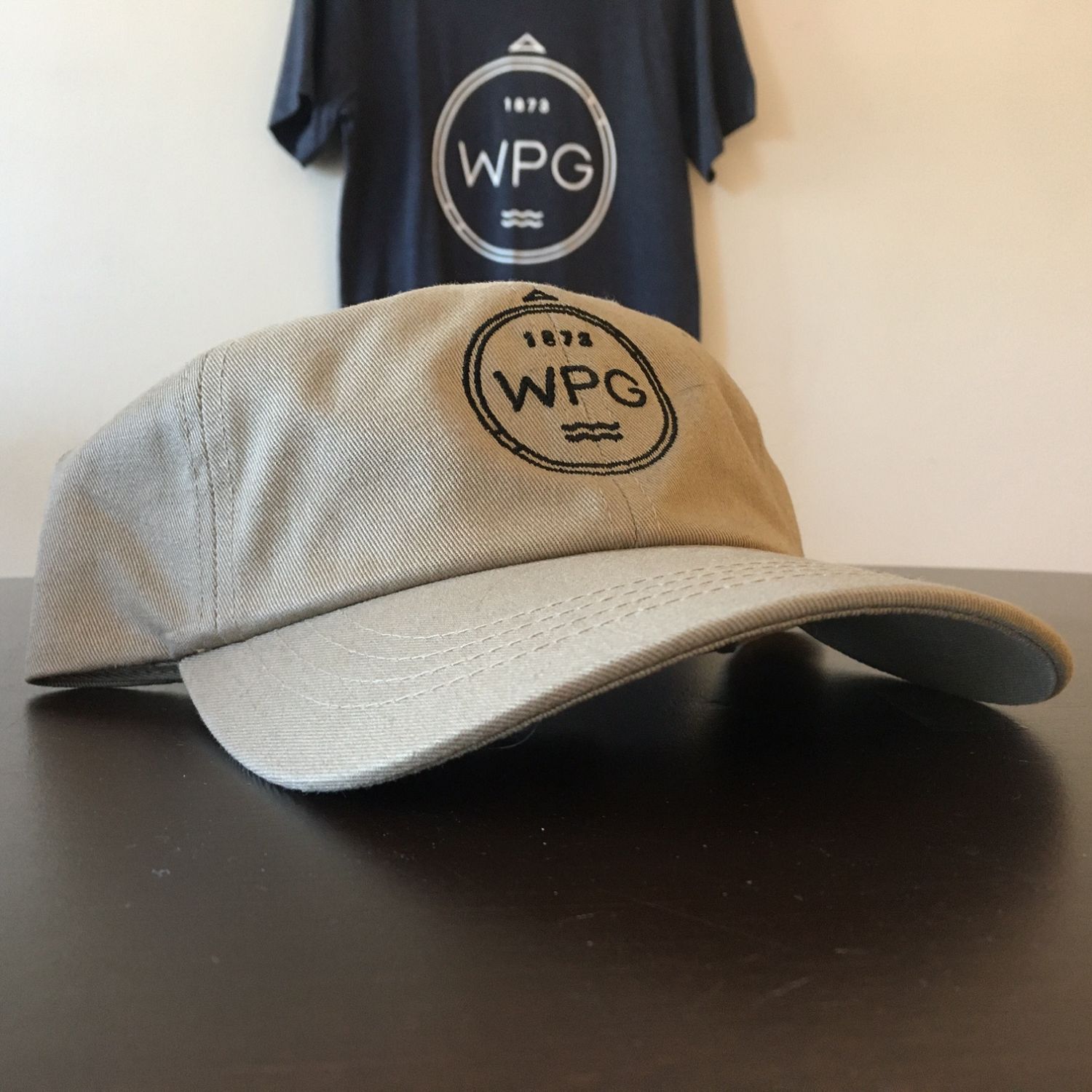 WPG Compass Dad Hat | Black on Tan sold by We Heart Winnipeg