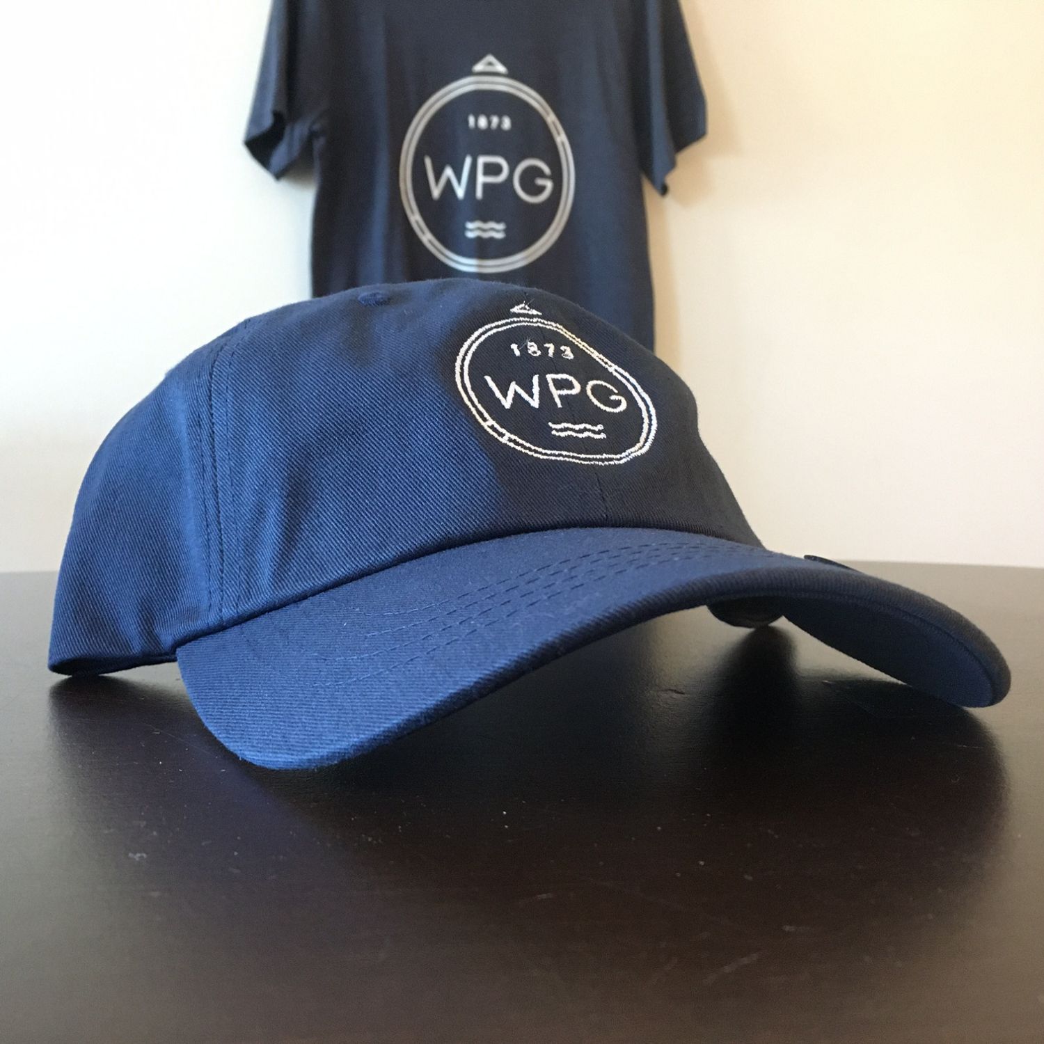 WPG Compass Dad Hat | White on Navy sold by We Heart Winnipeg
