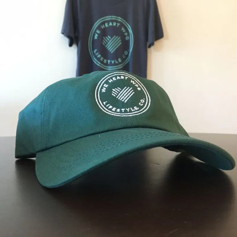 WHW Lifestyle Dad Hat | White on Forest sold by We Heart Winnipeg