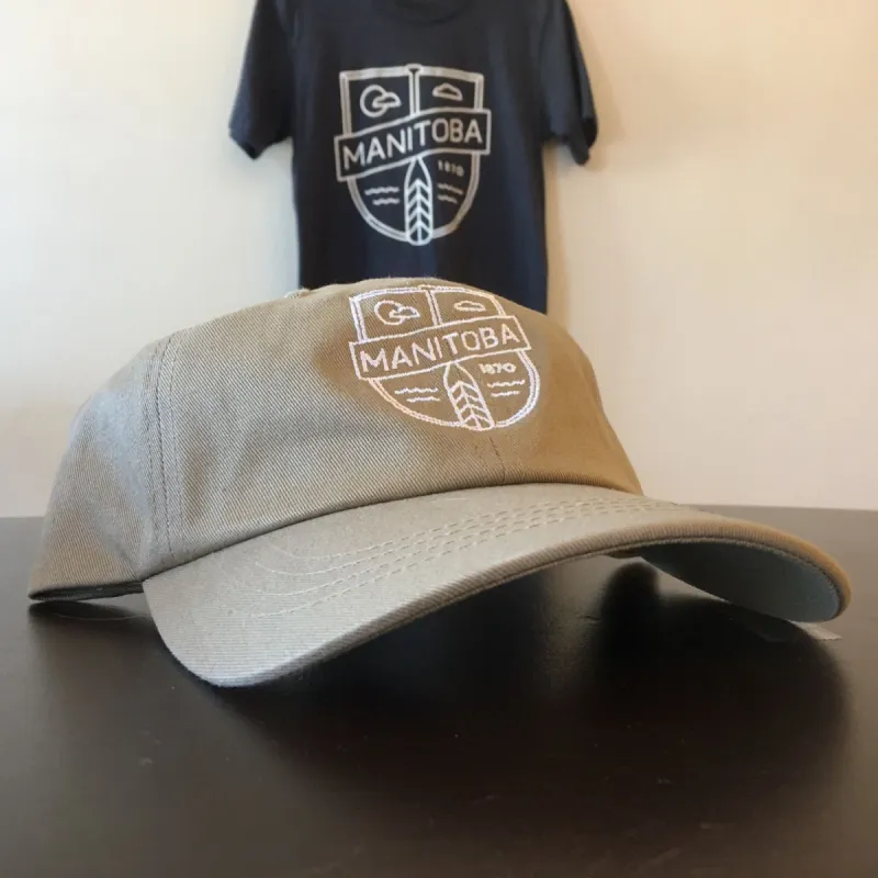 MB Cottage Dad Hat | White on Tan sold by We Heart Winnipeg